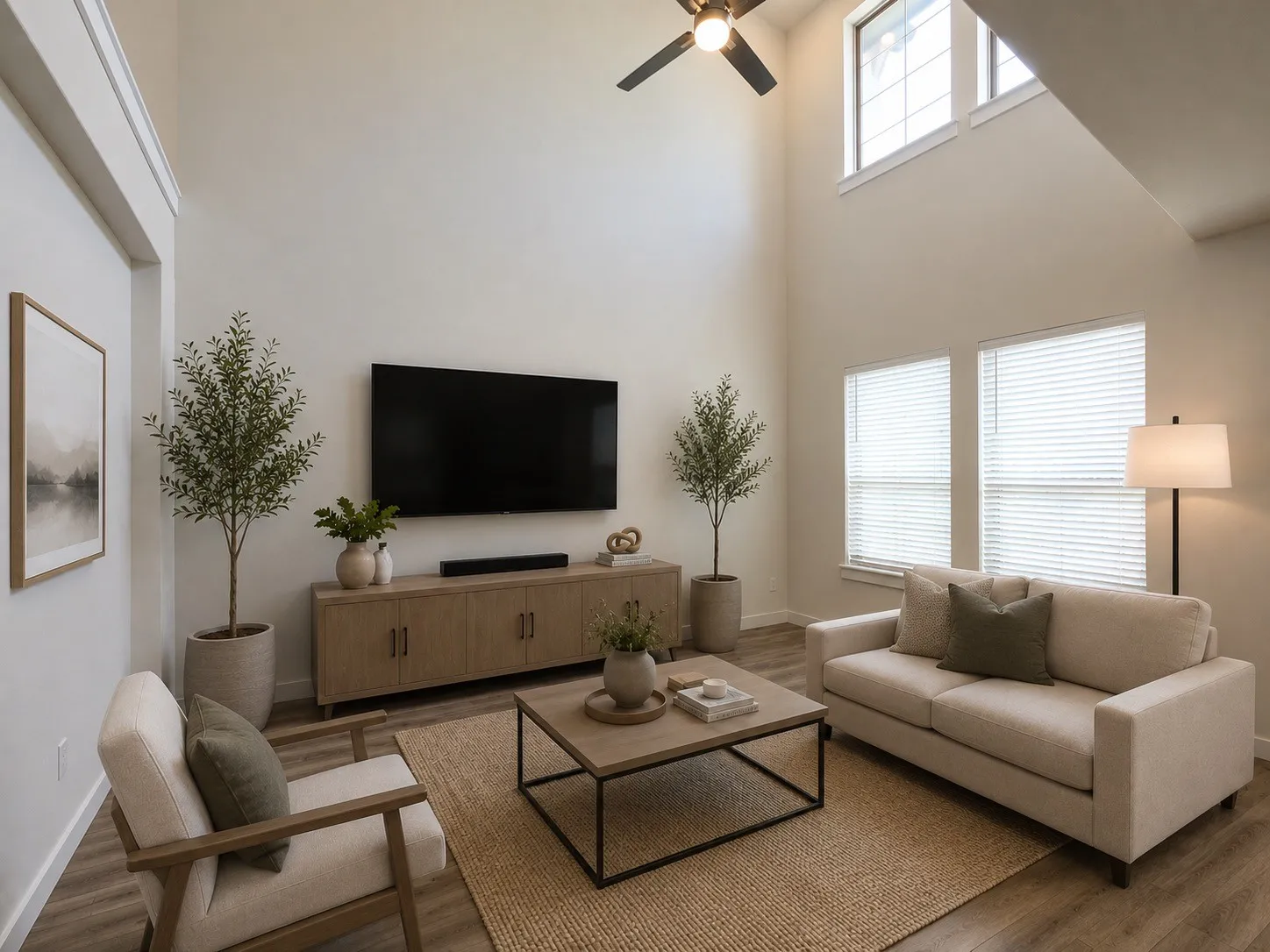 Virtually staged,.  Expansive living area featuring vaulted ceilings, wood-finish flooring, and natural light from multiple windows