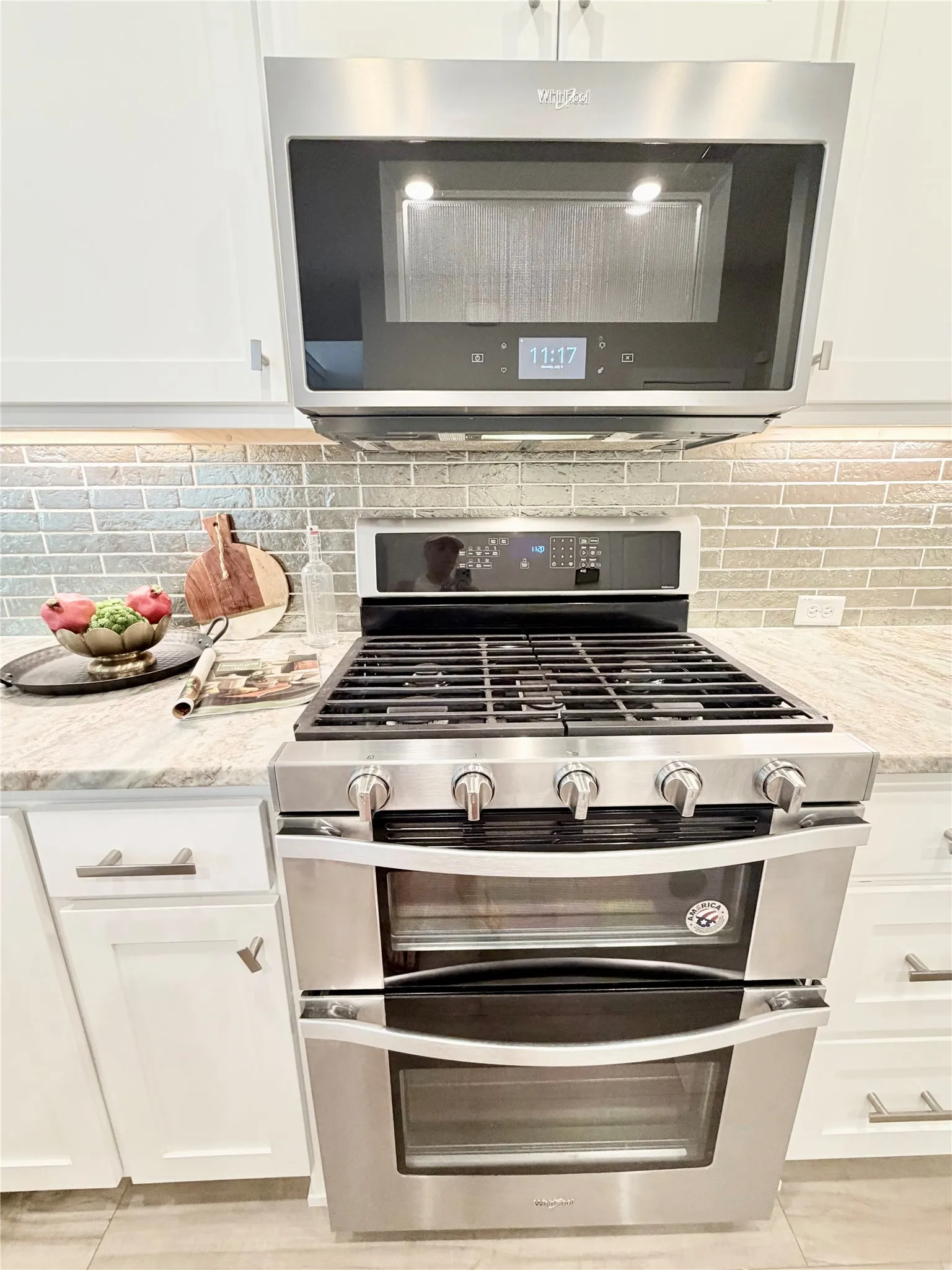 Gas cooktop range with double oven and microwave above