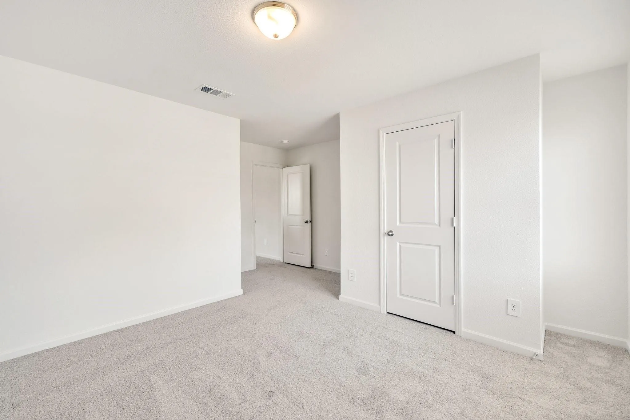 Neutral tone wall finishes, light-toned carpet flooring, recessed lighting, and white trim