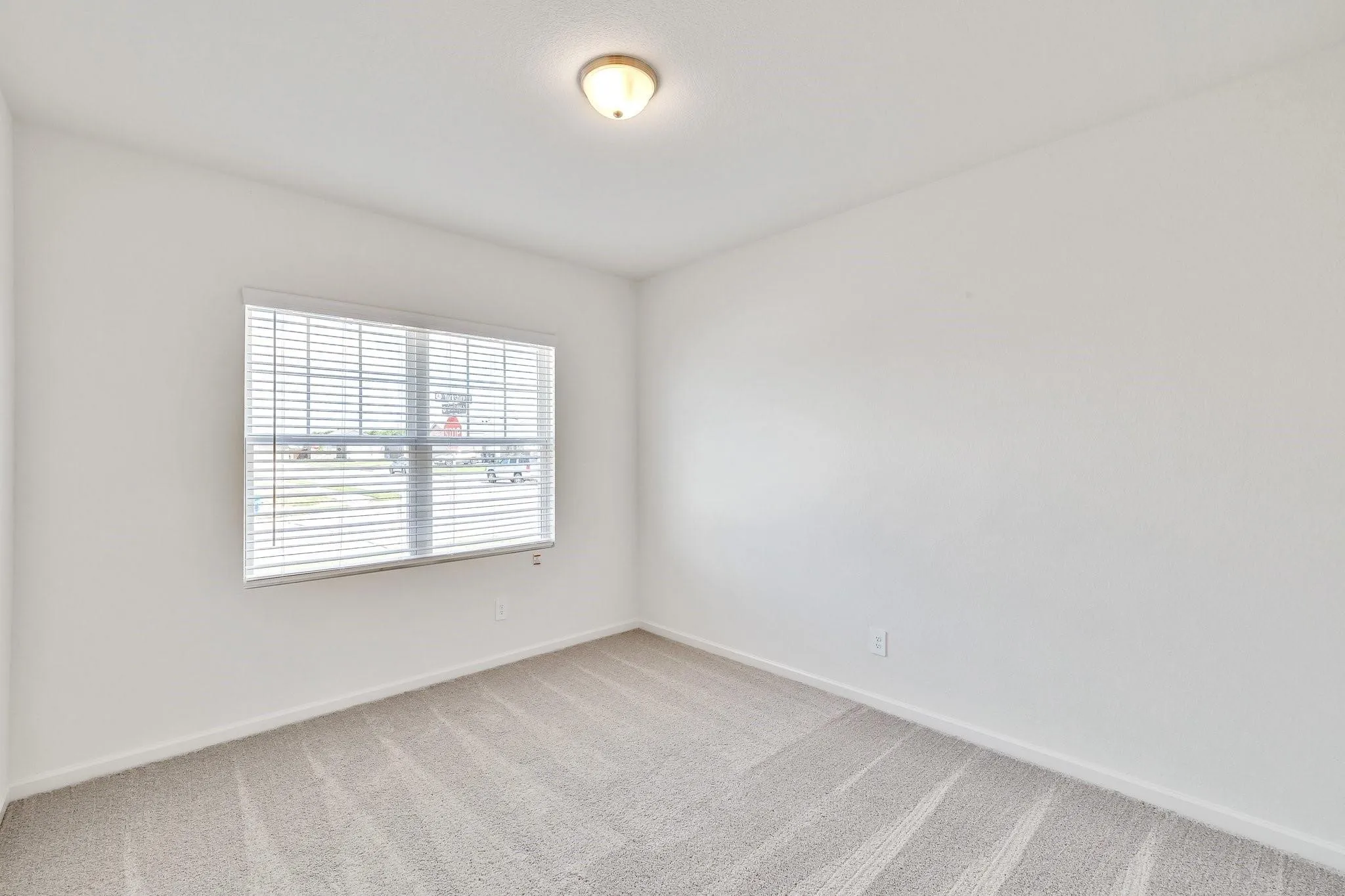Neutral-toned wall-to-wall carpeting in a light shade