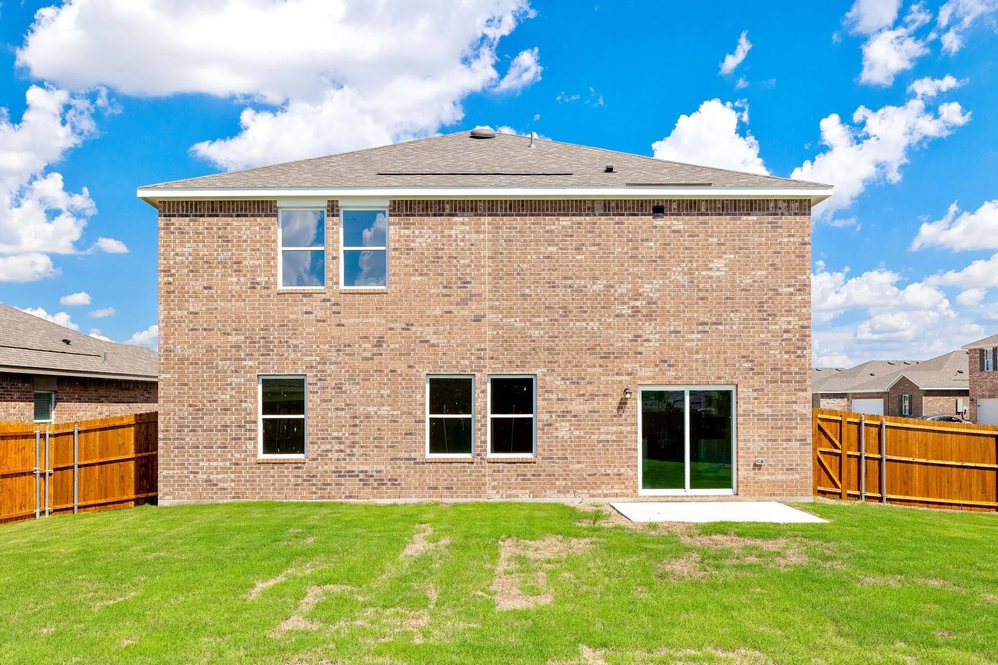 Expansive backyard featuring a manicured lawn and a privacy fence