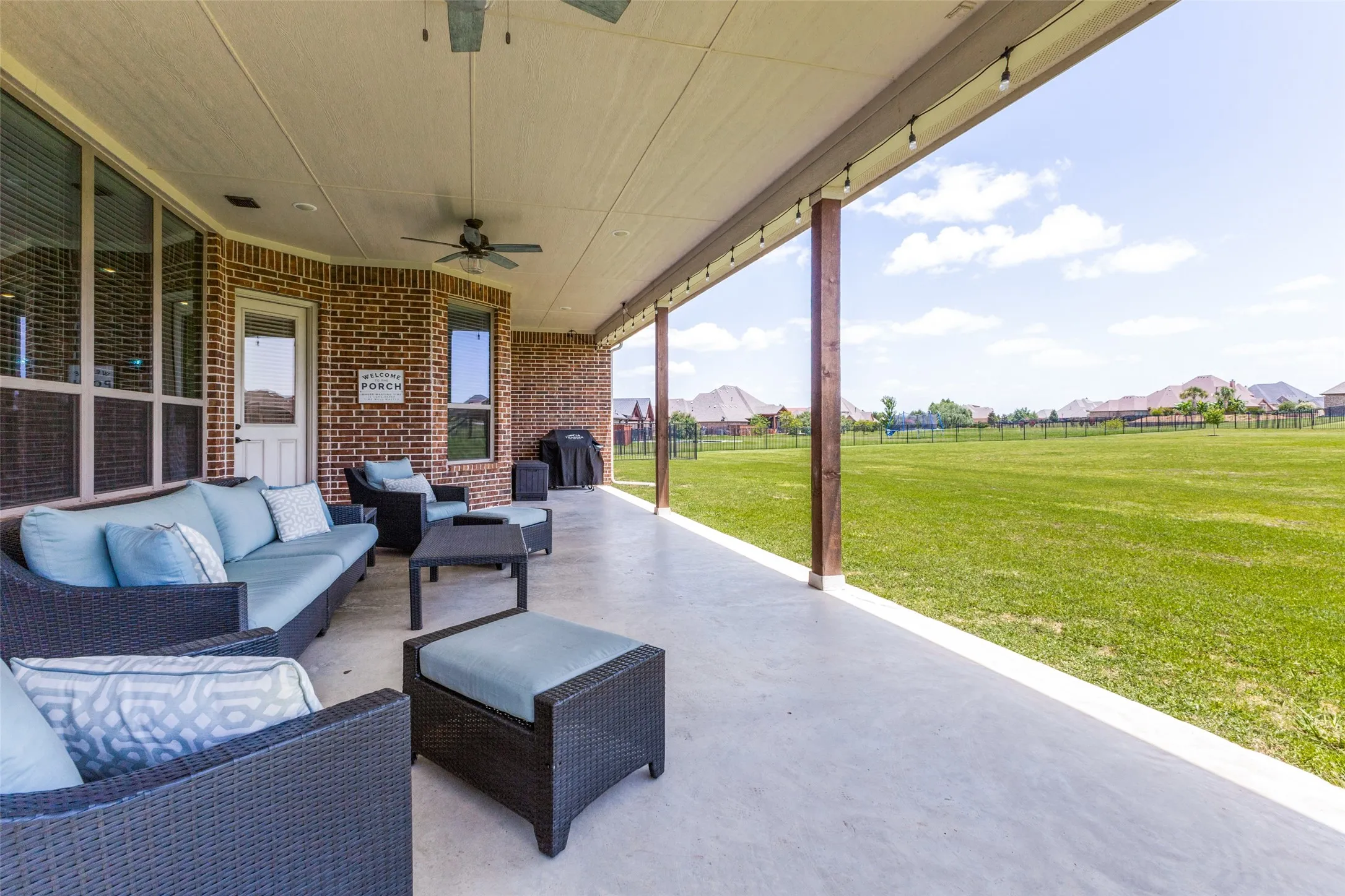 A covered patio like no other with enough space for cushy relaxing furniture!