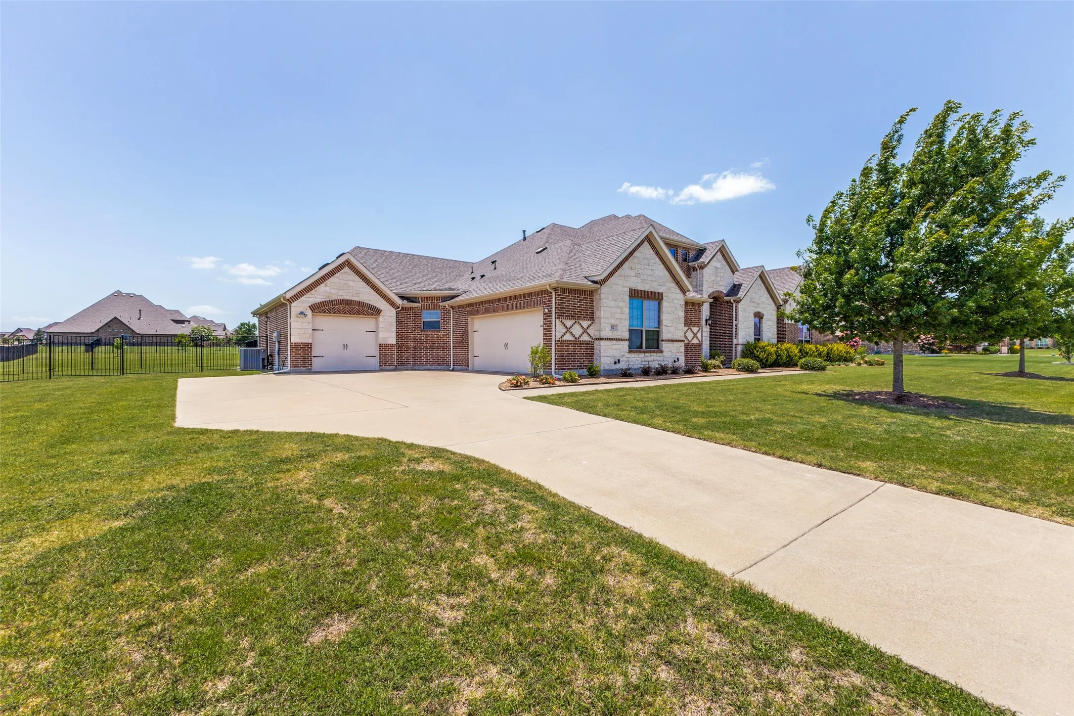 A Long driveway to two car AND one car garages.