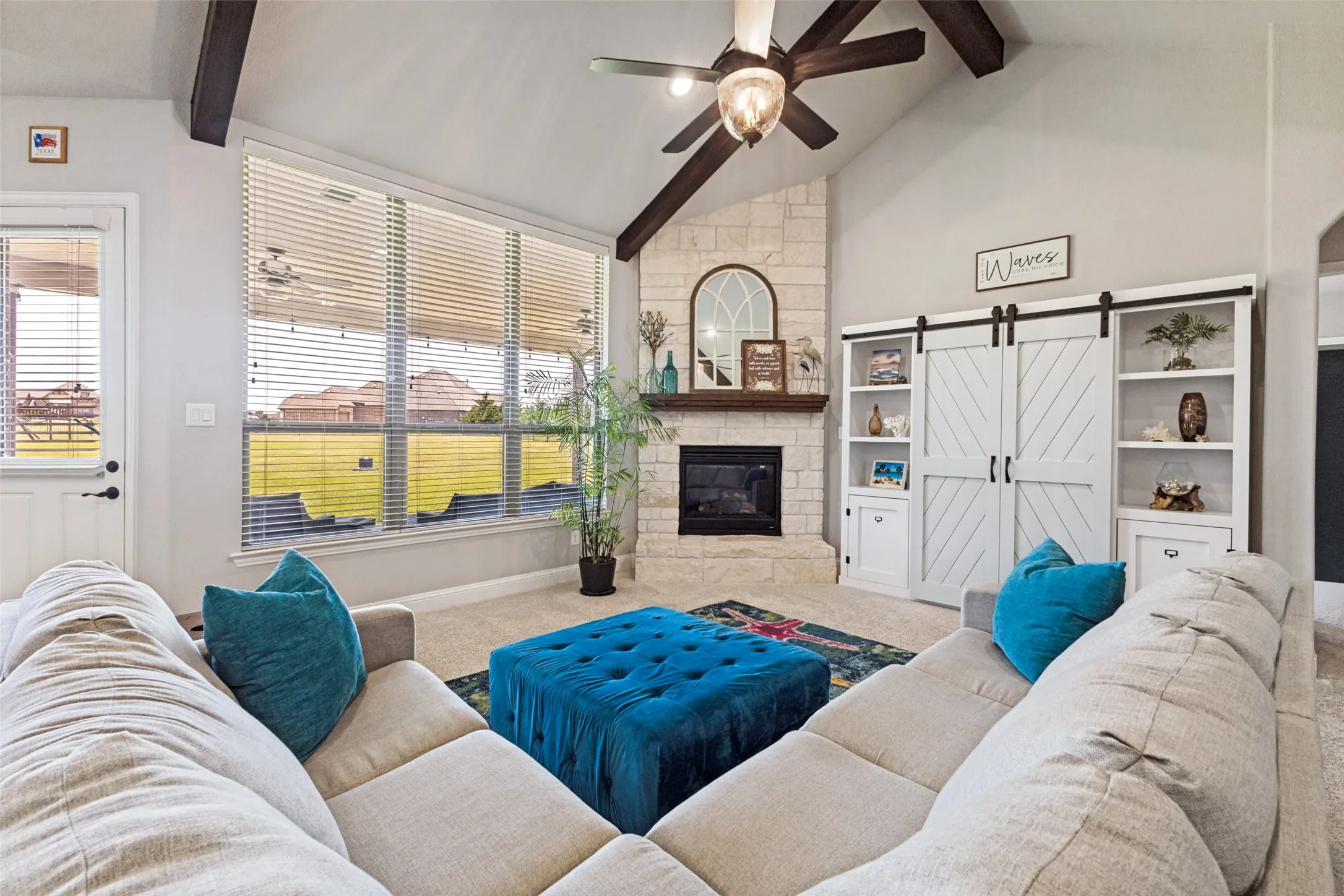 Oversized living room overlooking back yard from a wall of windows.