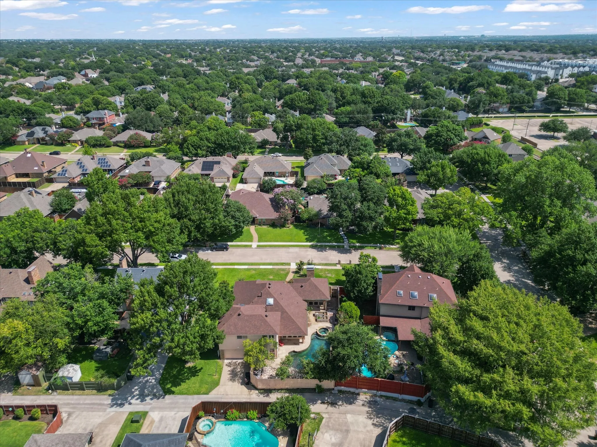 Aerial perspective showcasing a residential neighborhood with mature trees
