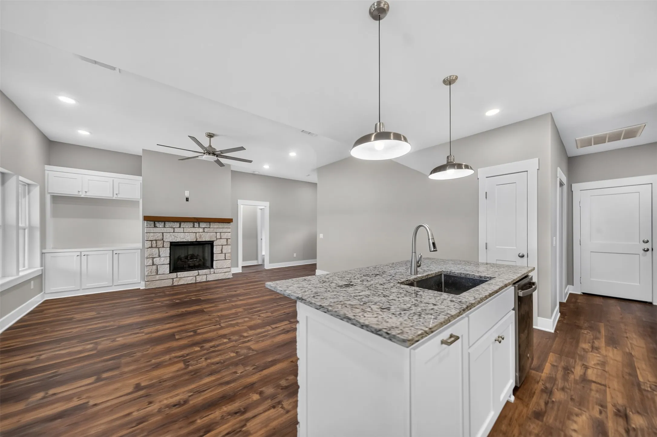 Kitchen island with granite countertop, undermount sink, and gooseneck faucet