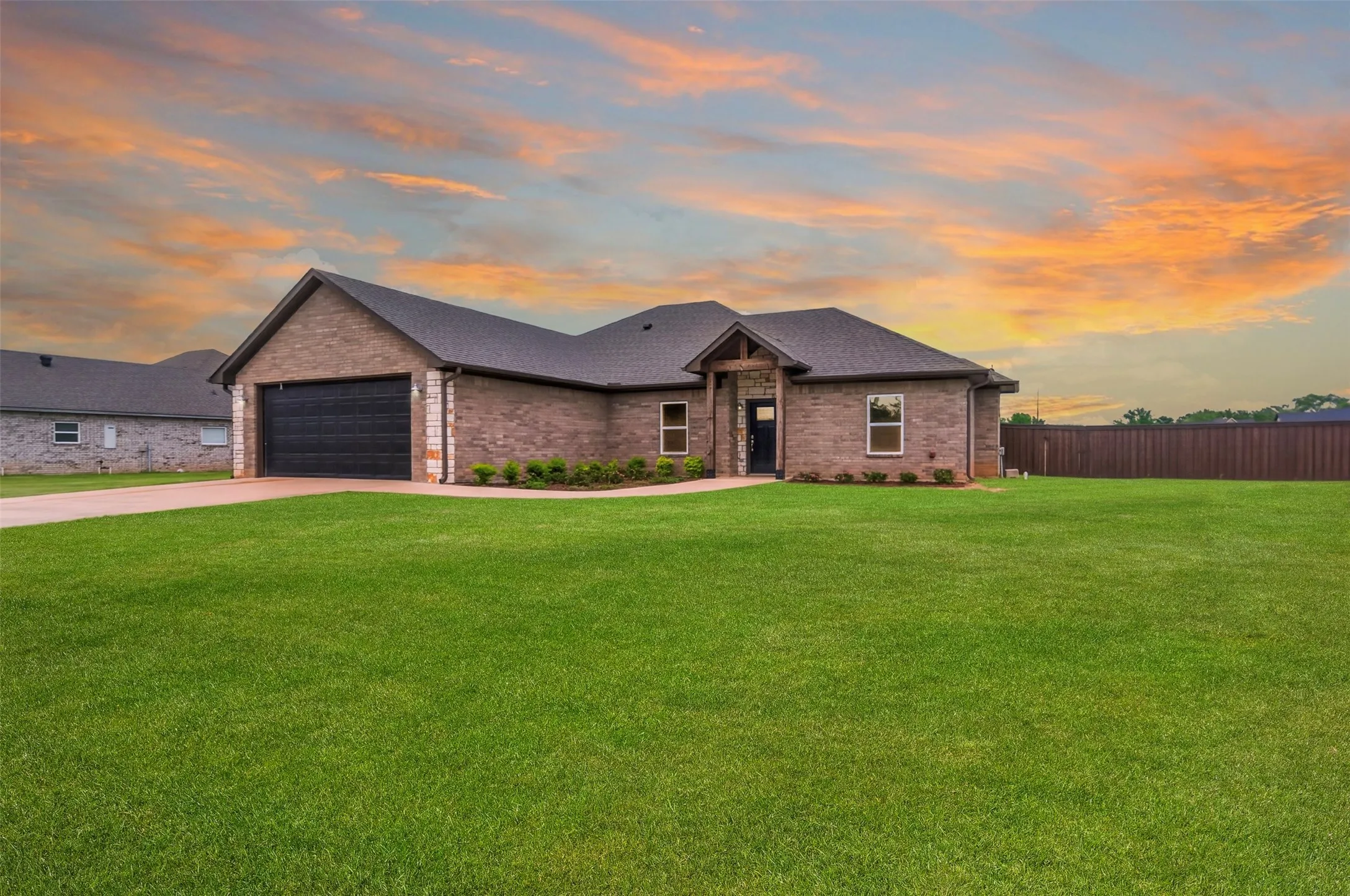 Brick exterior with stone accents and dark shingle roofing. photo enhanced.
