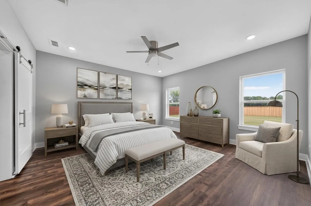 Spacious room featuring wood-finish flooring, light grey walls, and a ceiling fan with integrated lighting. Virtually Staged.