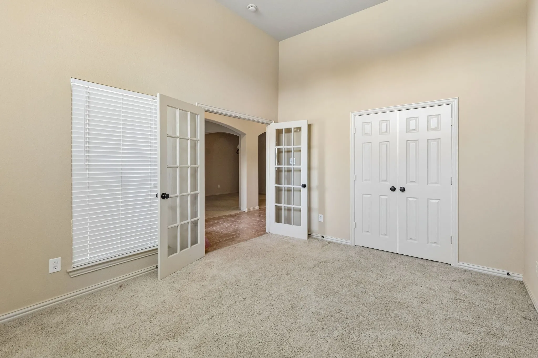 Standing in front of the windows and looking back. Sizable closet with hanging bar.