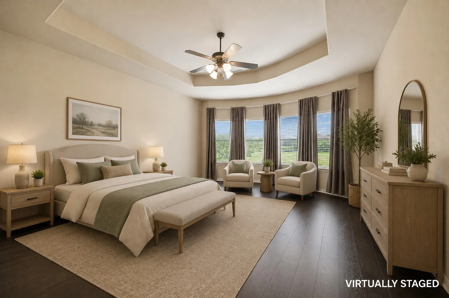 This owner's suite feels so luxurious with those stunning windows and tray ceiling.