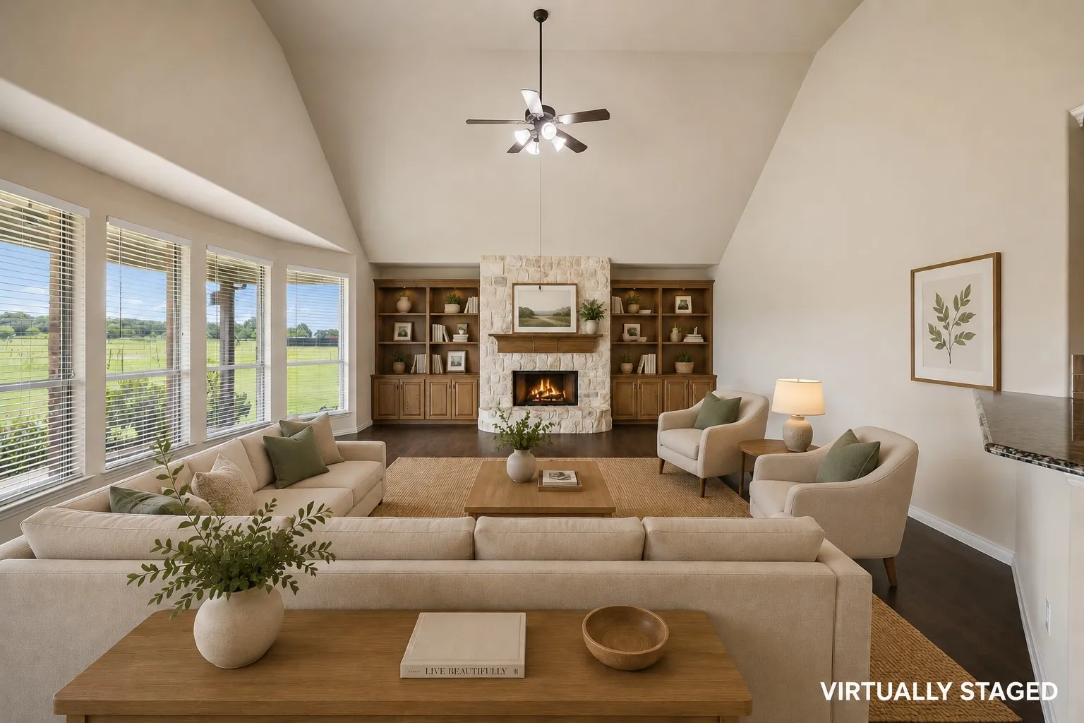 The living room with the floor to ceiling wood burning fireplace is spacious and stunning.