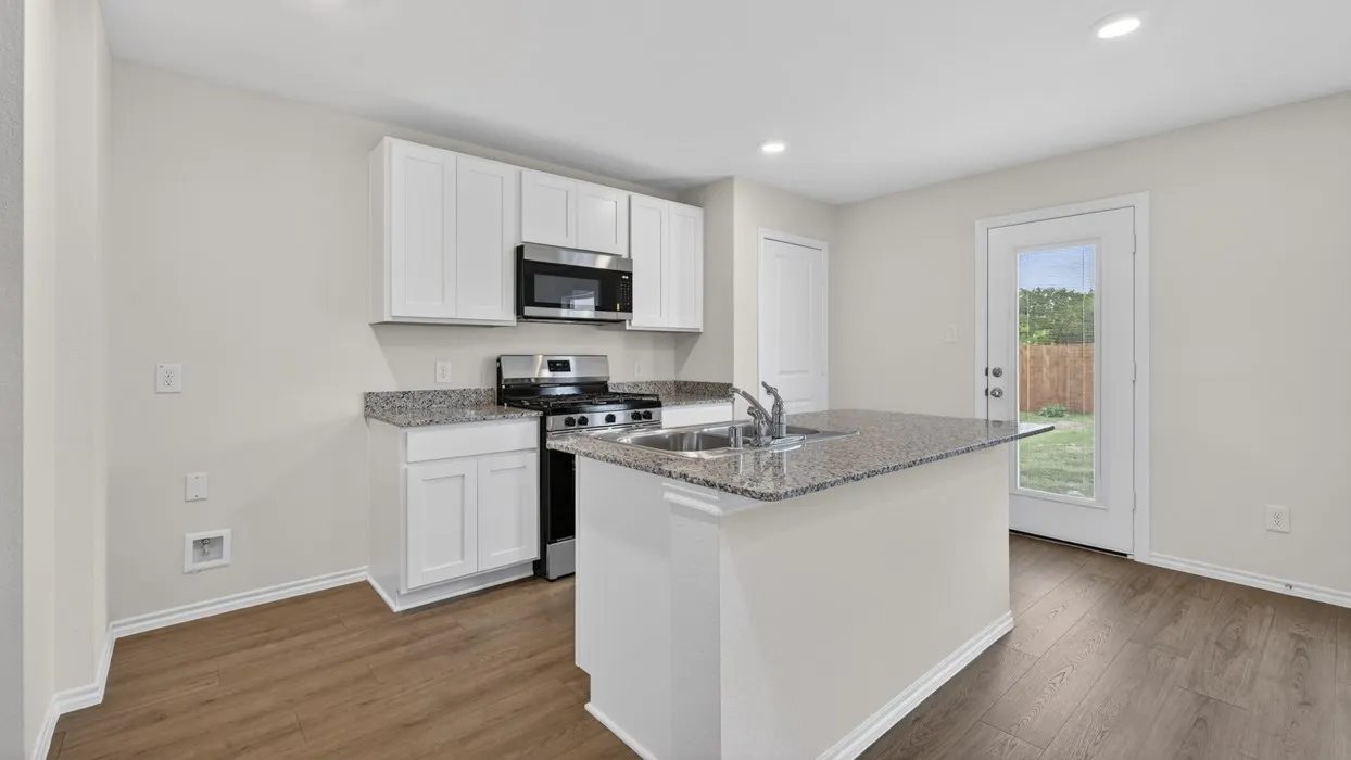 Kitchen featuring white cabinetry, stainless steel appliances, granite countertops, and wood-finish flooring