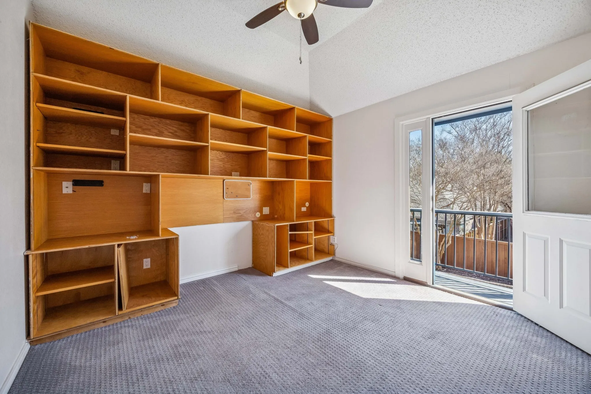 This 5th bedroom is currently the home office with balcony and a view of the backyard oasis.