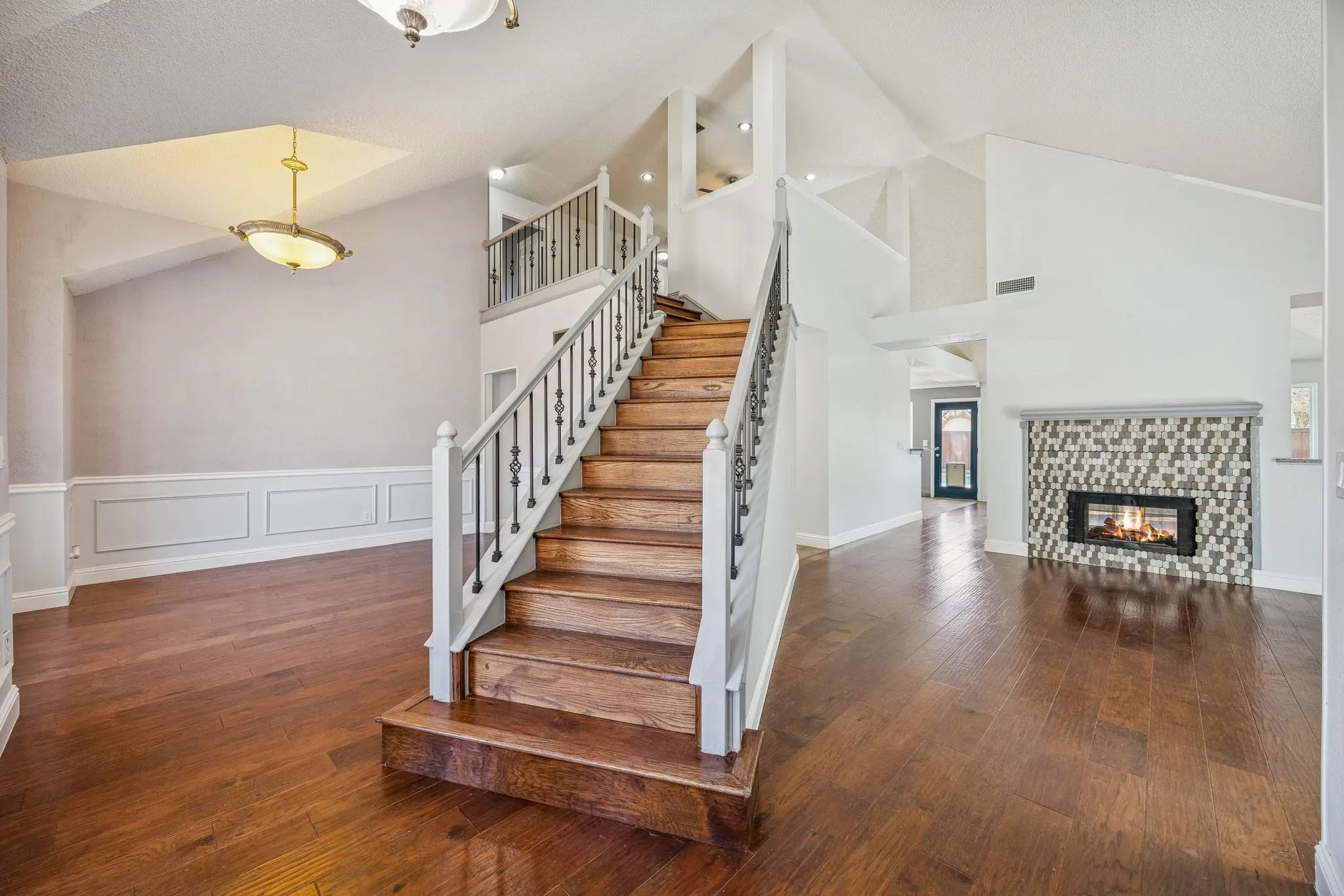 The hardwood floors and stairs are a beautiful dark wood.