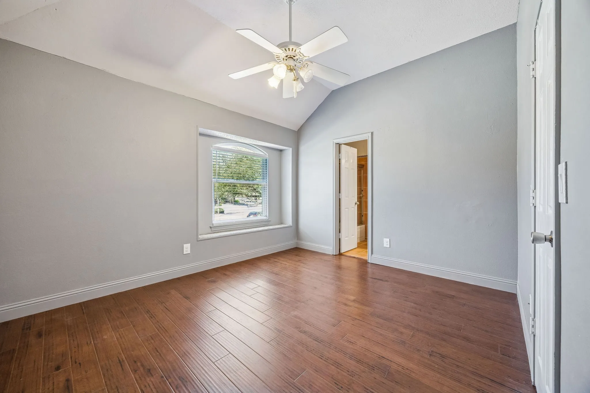 Second bedroom connected by the jack and jill bath.  All bedrooms have ceiling fans and wood floors.