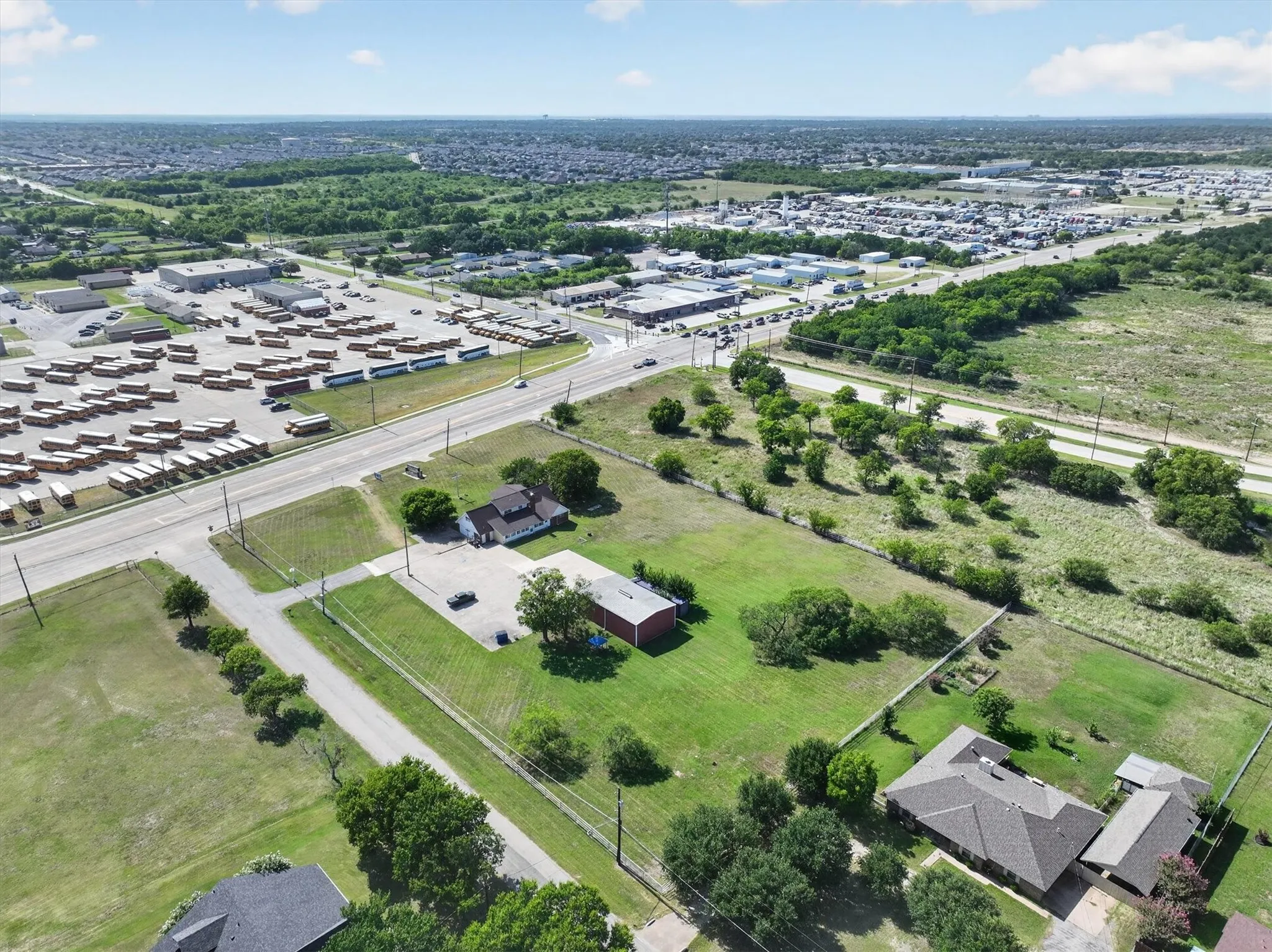 Aerial perspective showcasing multiple properties and surrounding infrastructure