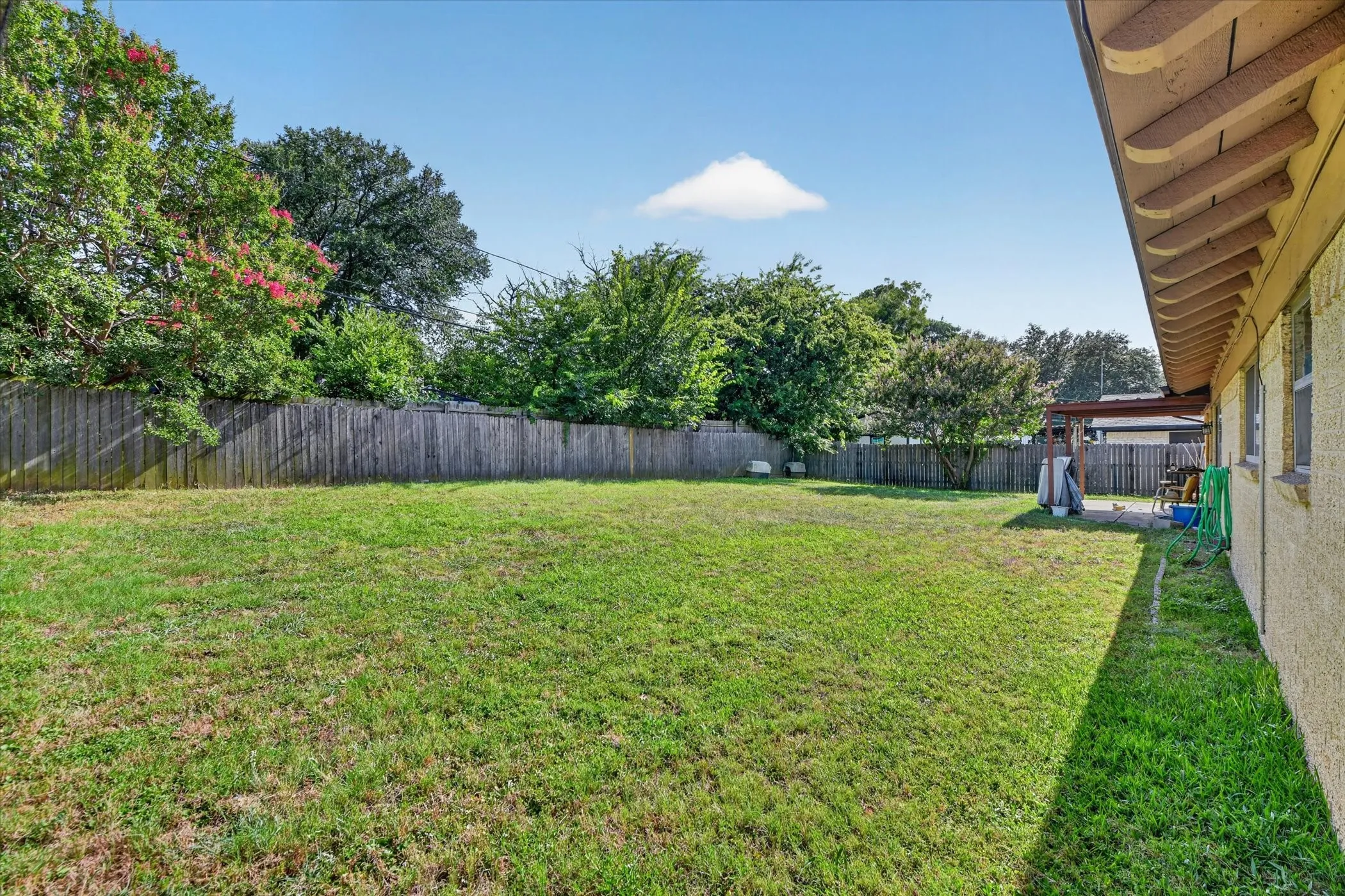 Expansive backyard featuring a large grass lawn
