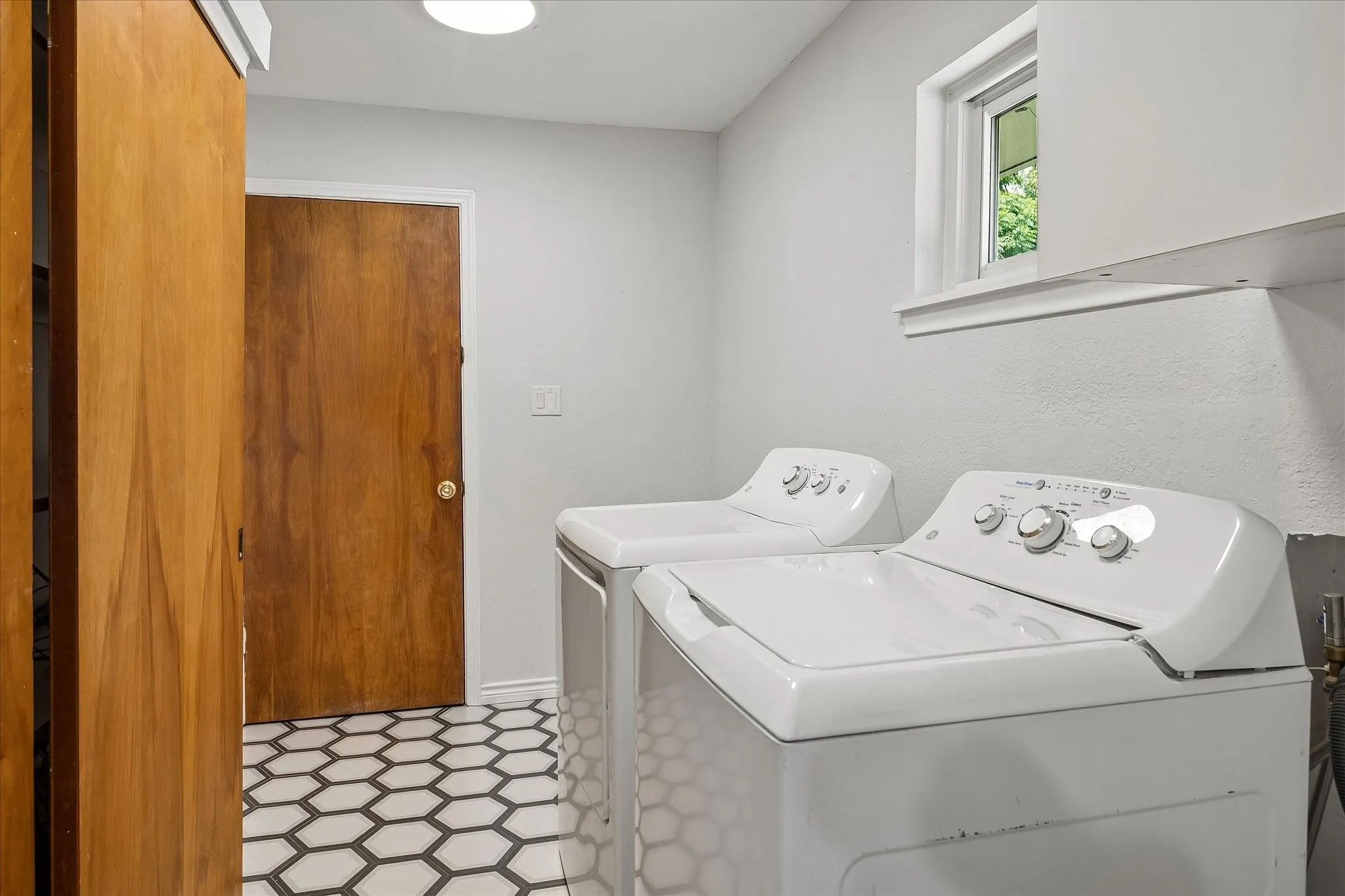 The laundry/utility room is quite large- allowing for a utility sink and additional cabinetry to be added. It is also conveniently located between the attached garage and kitchen. A large utility closet is in this space as well.