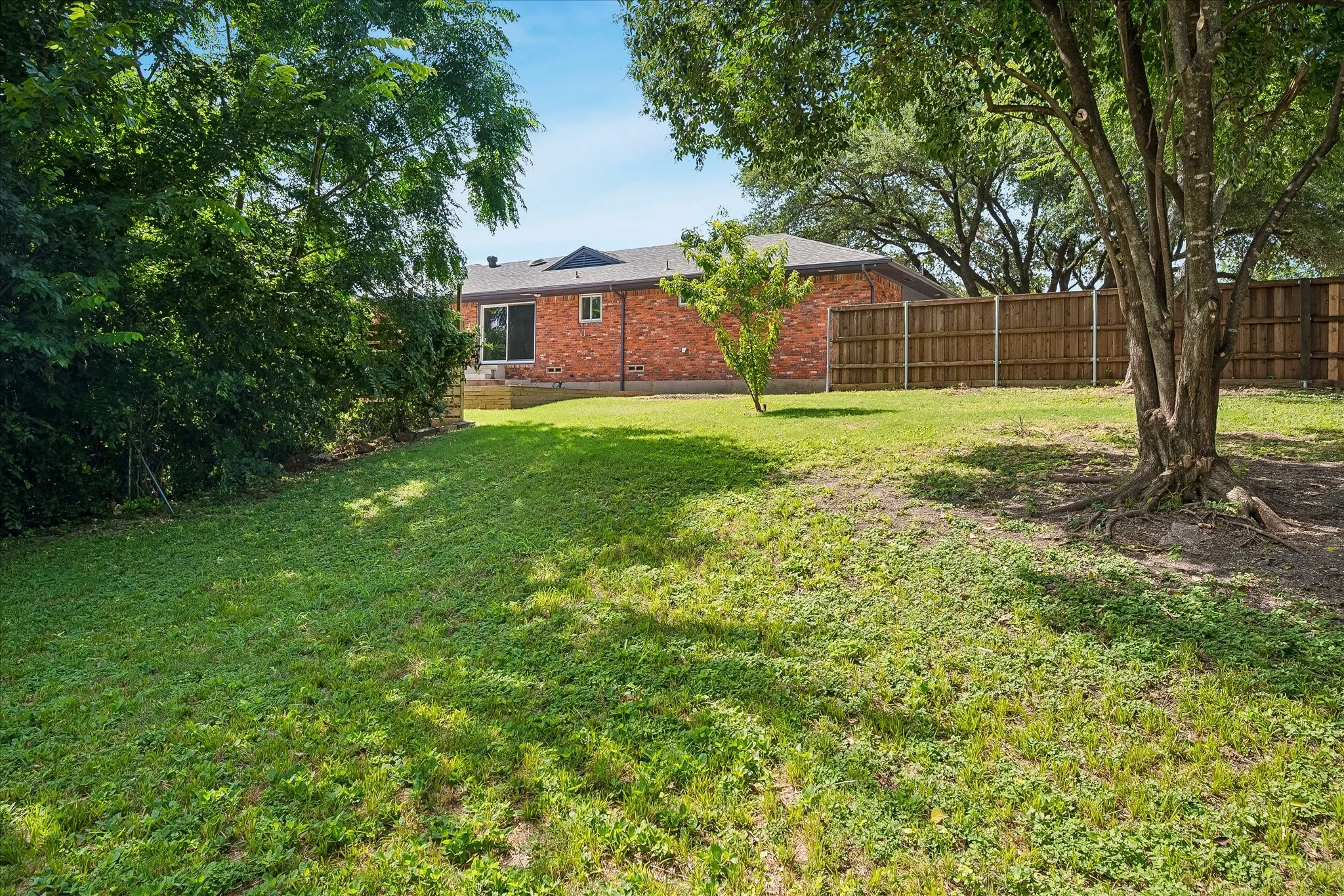 Expansive, fenced & private backyard abutting a creek and small wooded area provides exceptional privacy and plenty of space for kids - or the dog- to run and play- or plenty of room for a large pool as well!