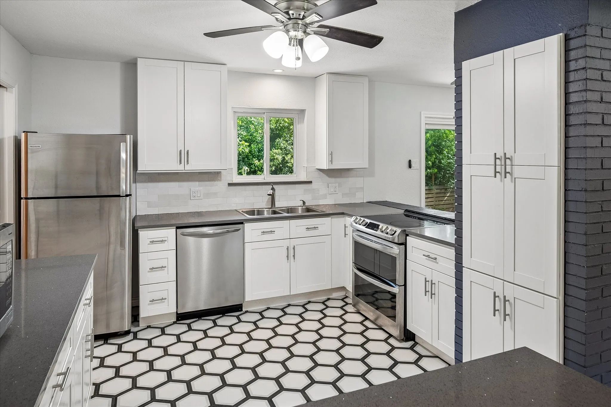 Kitchen completely renovated and taken to the studs in 2019. Quartzite countertops, new cabinetry, double stainless steel sink with window looking out to backyard. All appliances convey with the sale of the home.