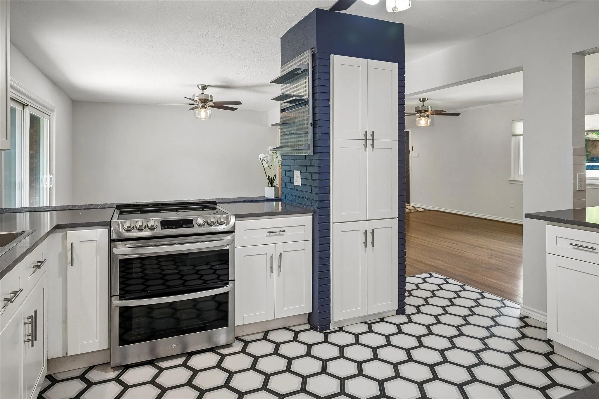 Built in pantry as well as spice rack on wall next to range.