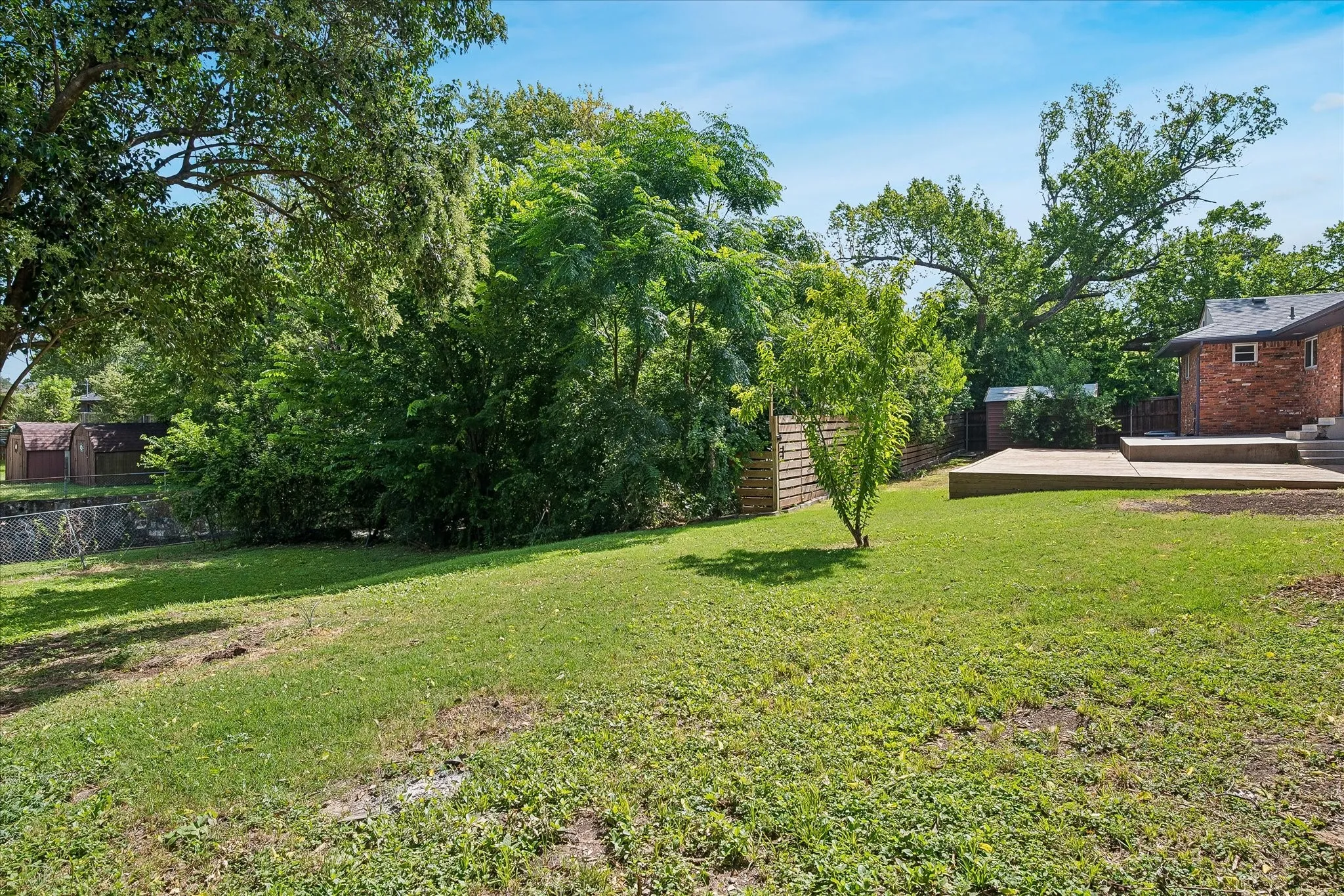 Expansive, fenced & private backyard abutting a creek and small wooded area provides exceptional privacy and plenty of space for kids - or the dog- to run and play- or plenty of room for a large pool as well!