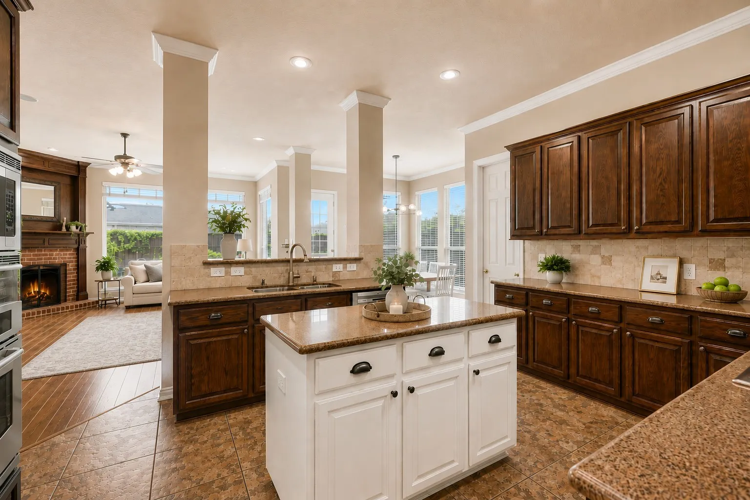 Kitchen with a center island, wood cabinetry, built-in stainless steel appliances, and a tile backsplash