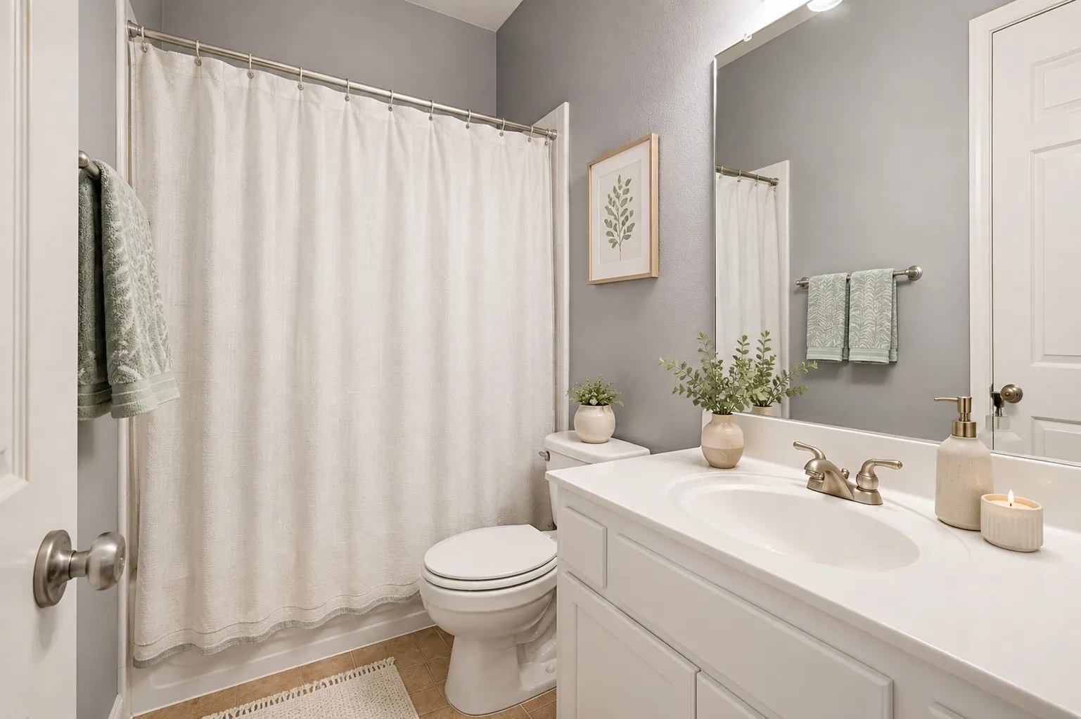 White vanity with an integrated sink, brushed nickel faucet, and a large wall-mounted mirror