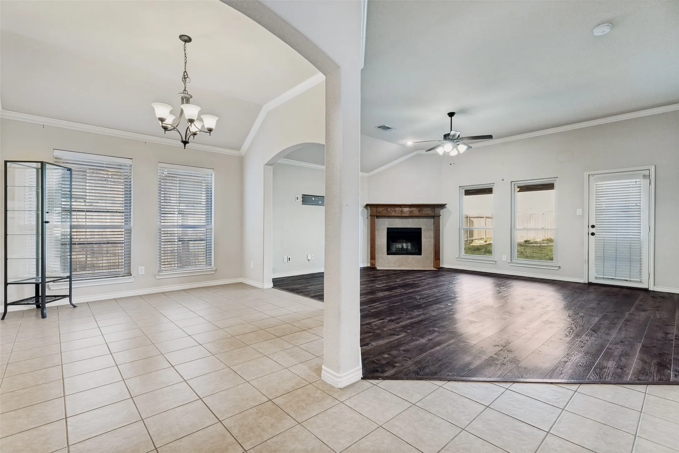 Spacious interior featuring a combination of square tile flooring and wood-finish flooring