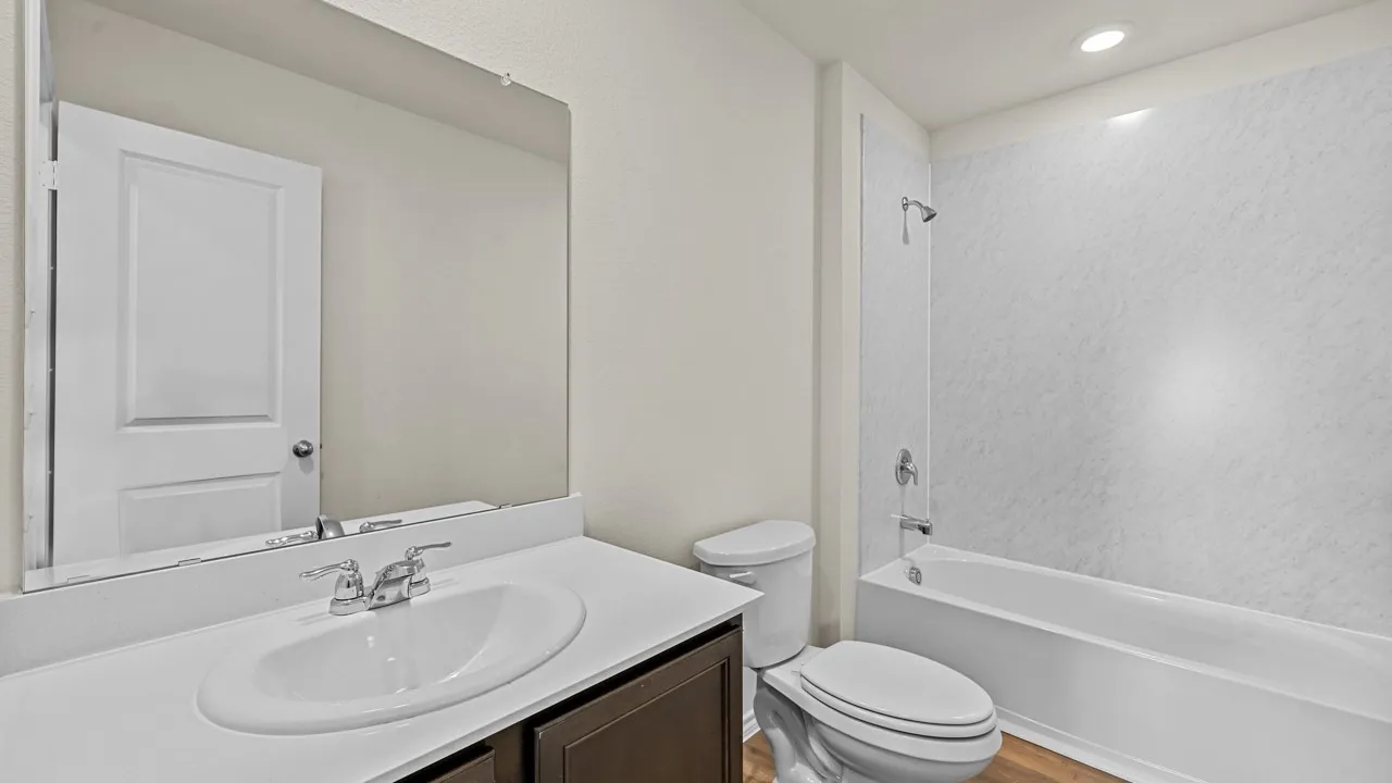 Bathroom featuring a single vanity with a white countertop, chrome faucet, and integrated sink