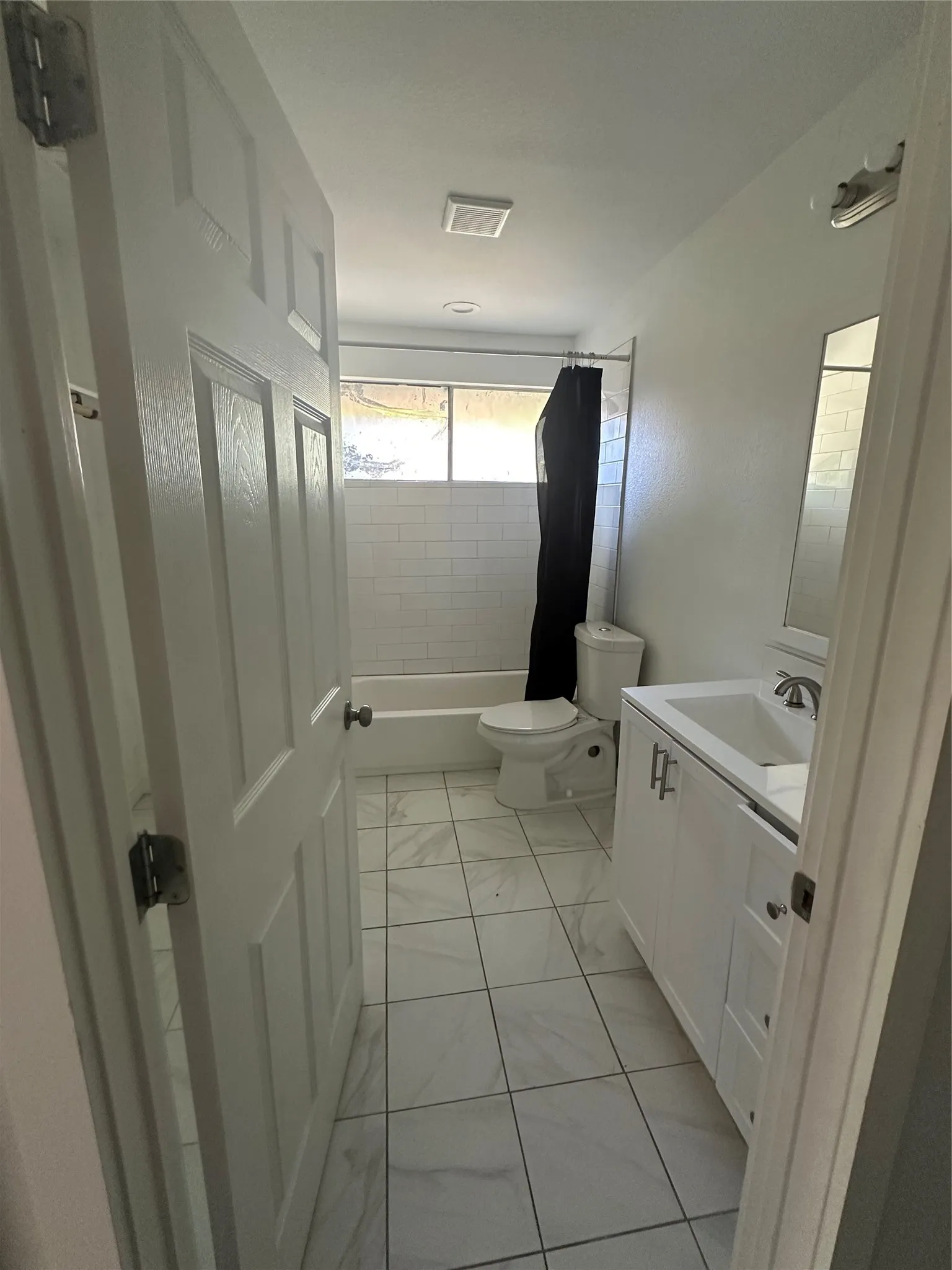 Full bathroom with washer and dryer hookups. First door on the left in the hallway.