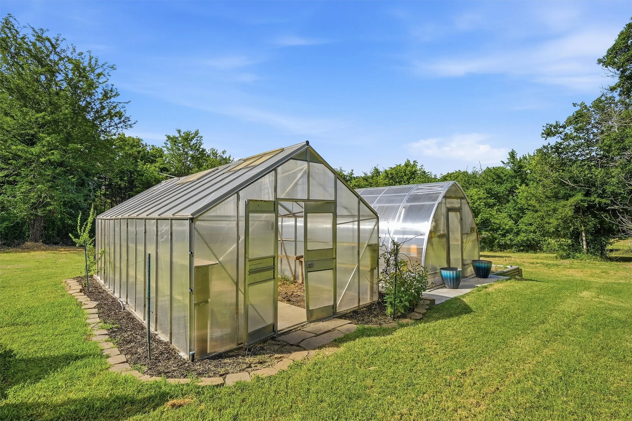 Two dedicated greenhouses with transparent paneling