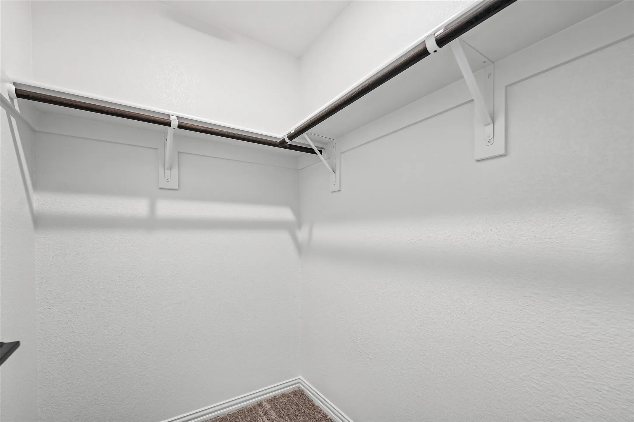 Corner closet with integrated shelving and hanging rods