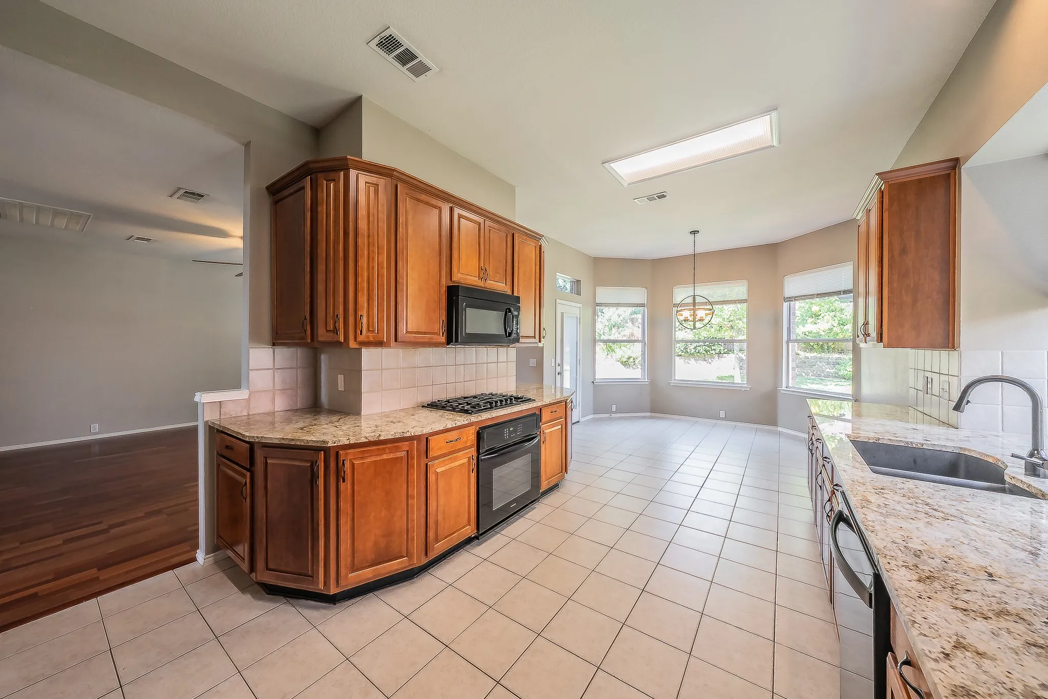 Kitchen featuring wood cabinetry, integrated appliances, and a tiled backsplash