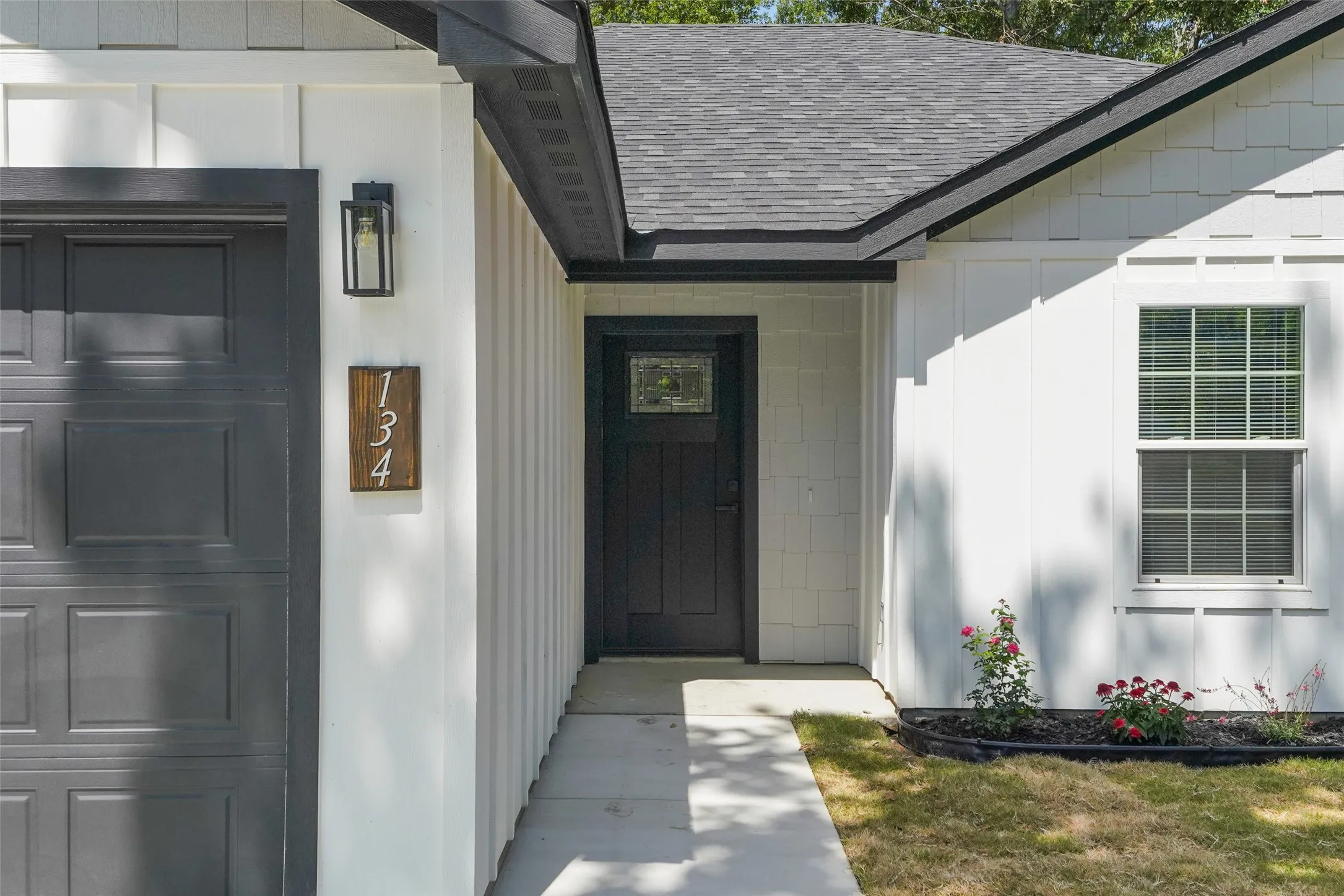 White board and batten siding with contrasting dark trim details