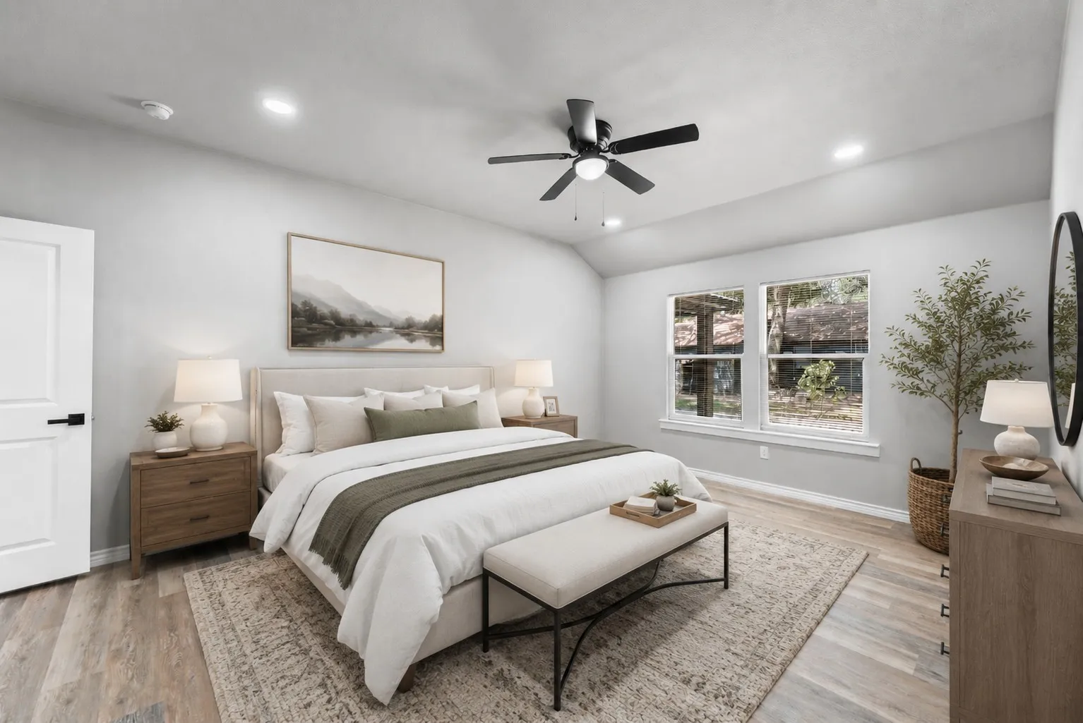 Spacious room featuring vaulted ceilings, wood-finish flooring, recessed lighting, and a contemporary ceiling fan