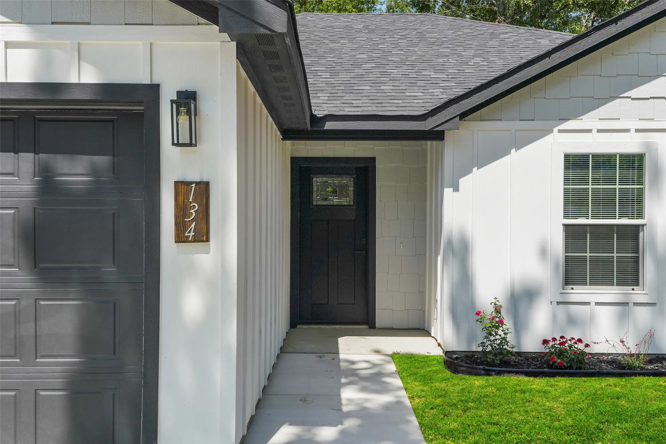 Crisp white board and batten siding with black trim accents