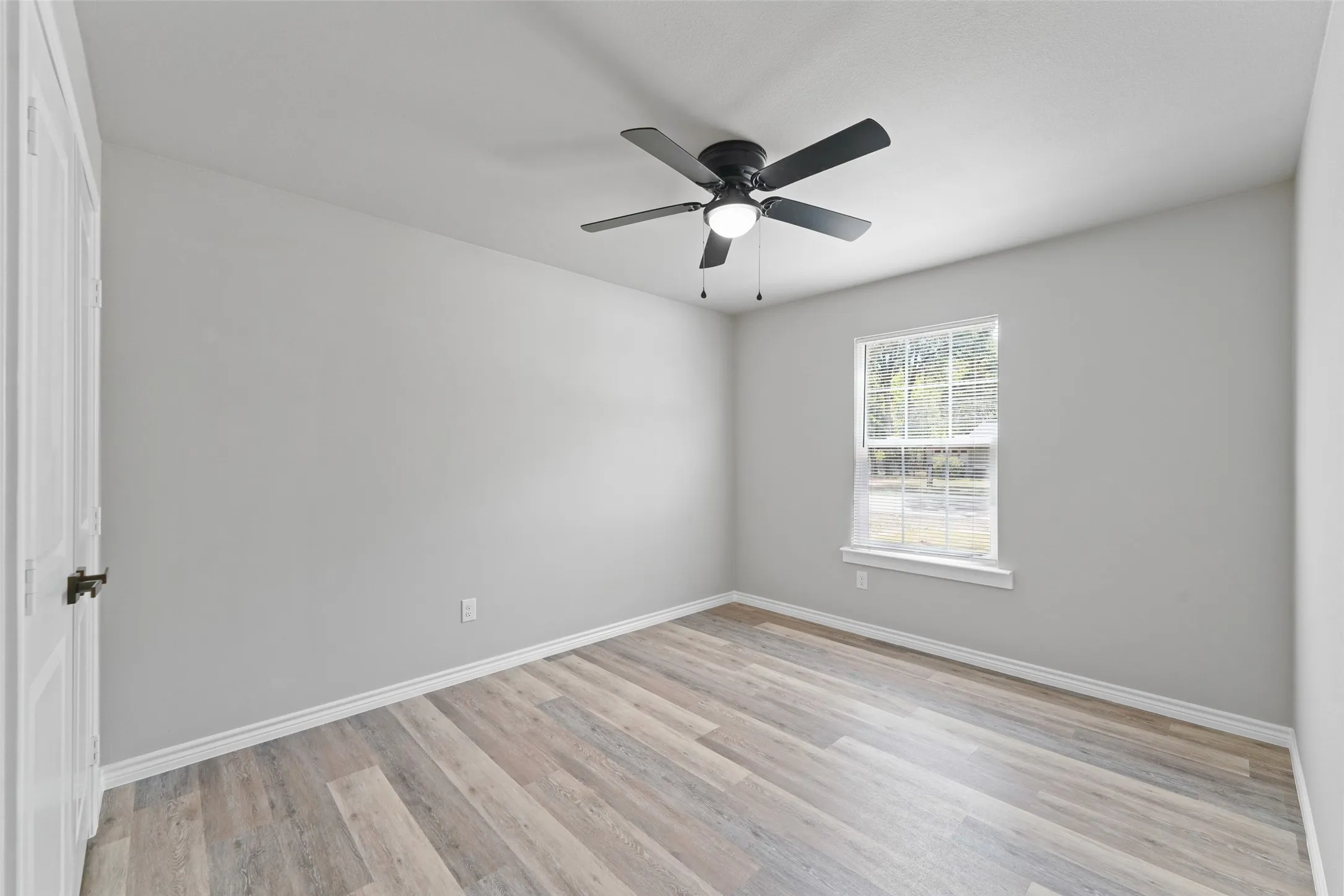 Light gray wall tones with wood-finish flooring