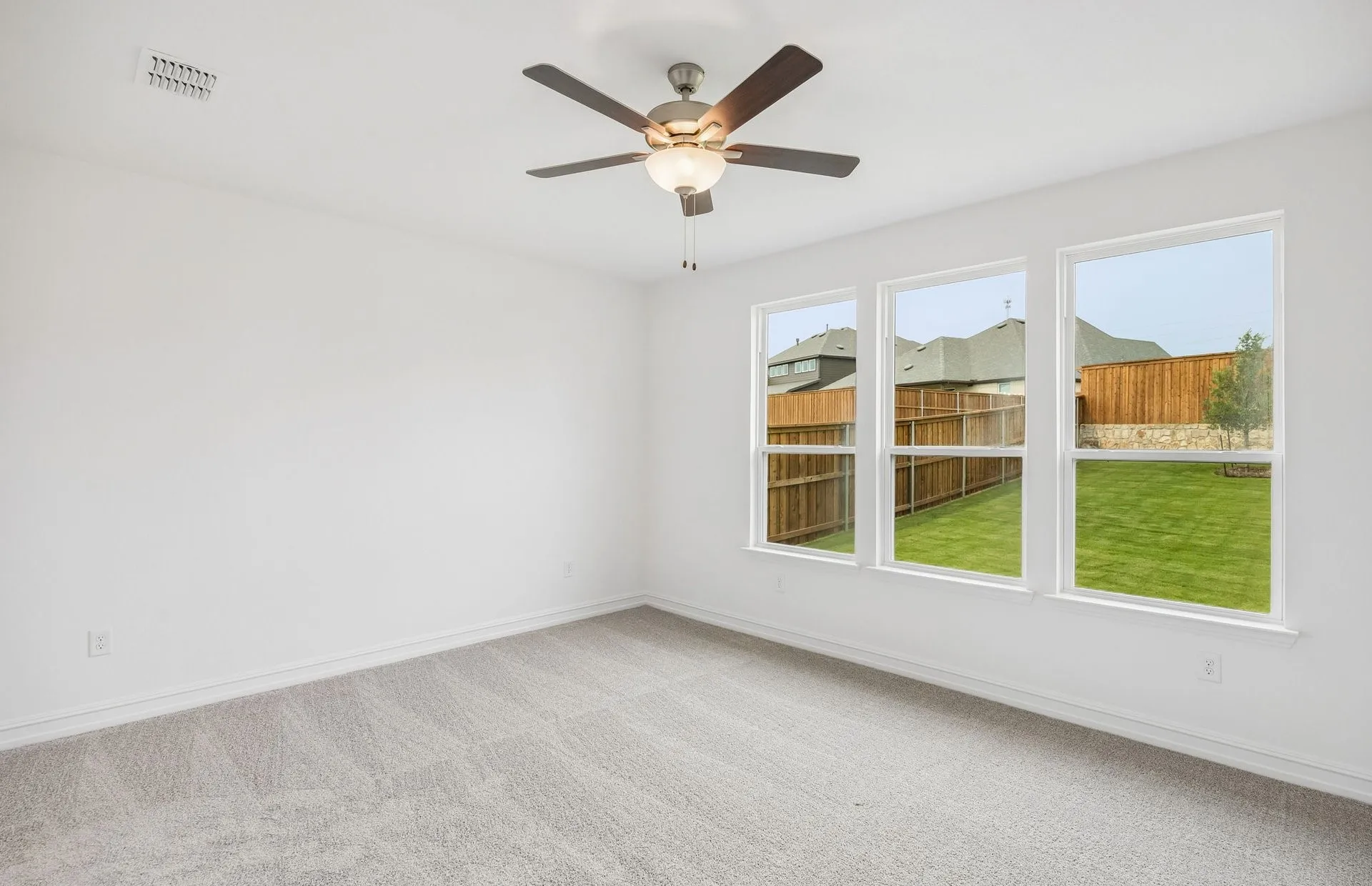 Primary bedroom with large windows