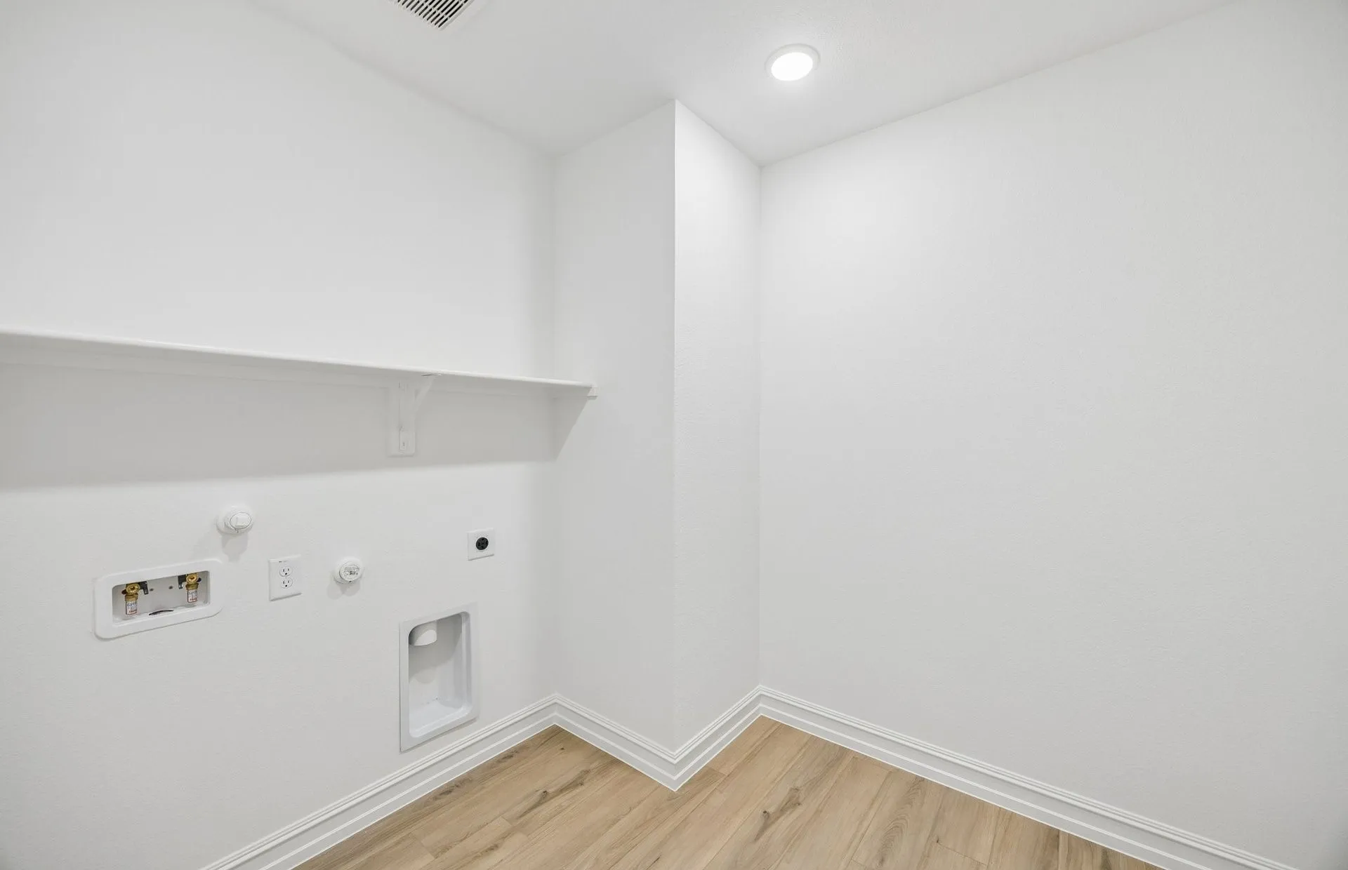 Laundry room with built-in shelving