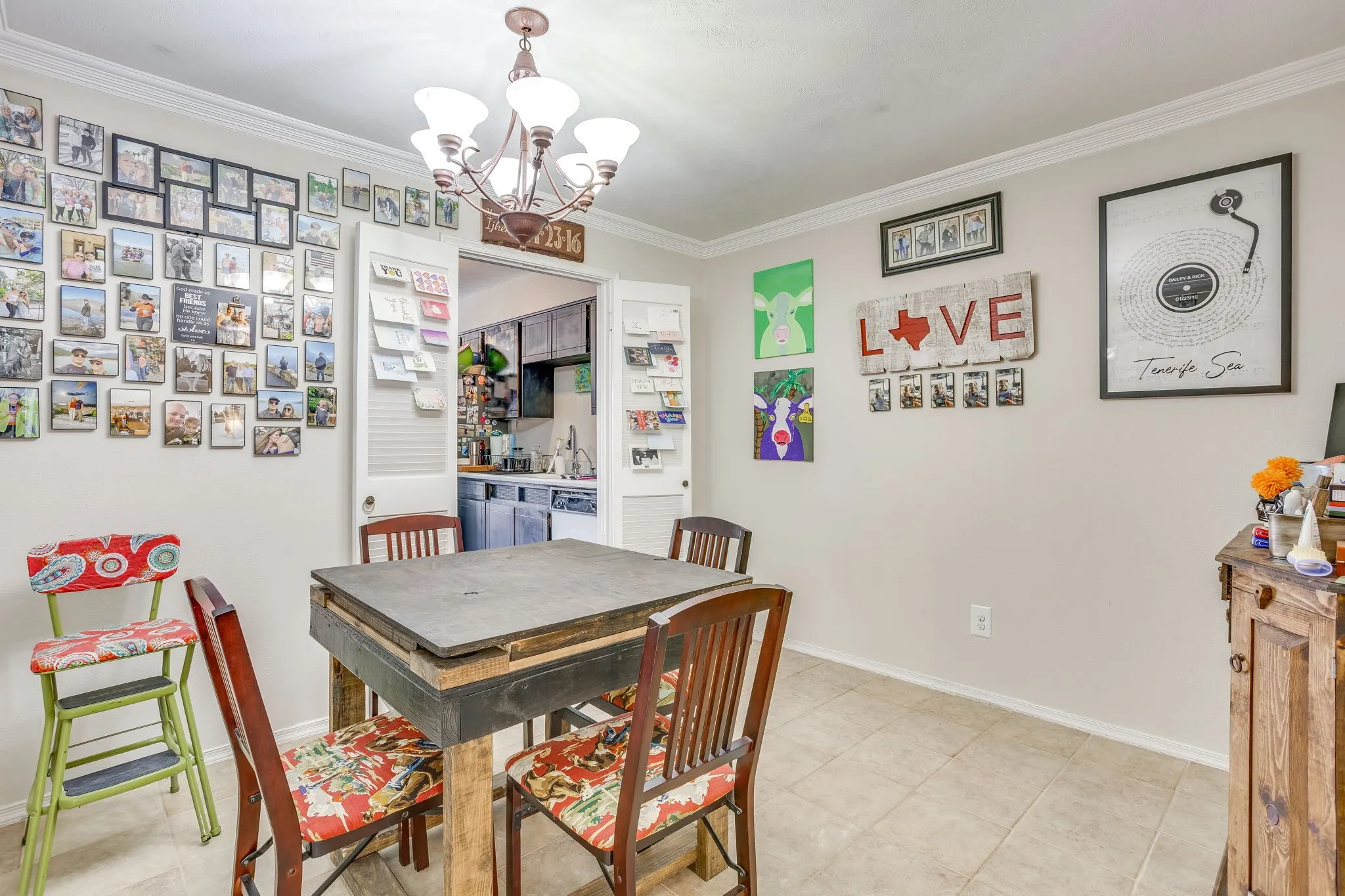 Dining area featuring neutral wall paint, crown molding, and tile flooring