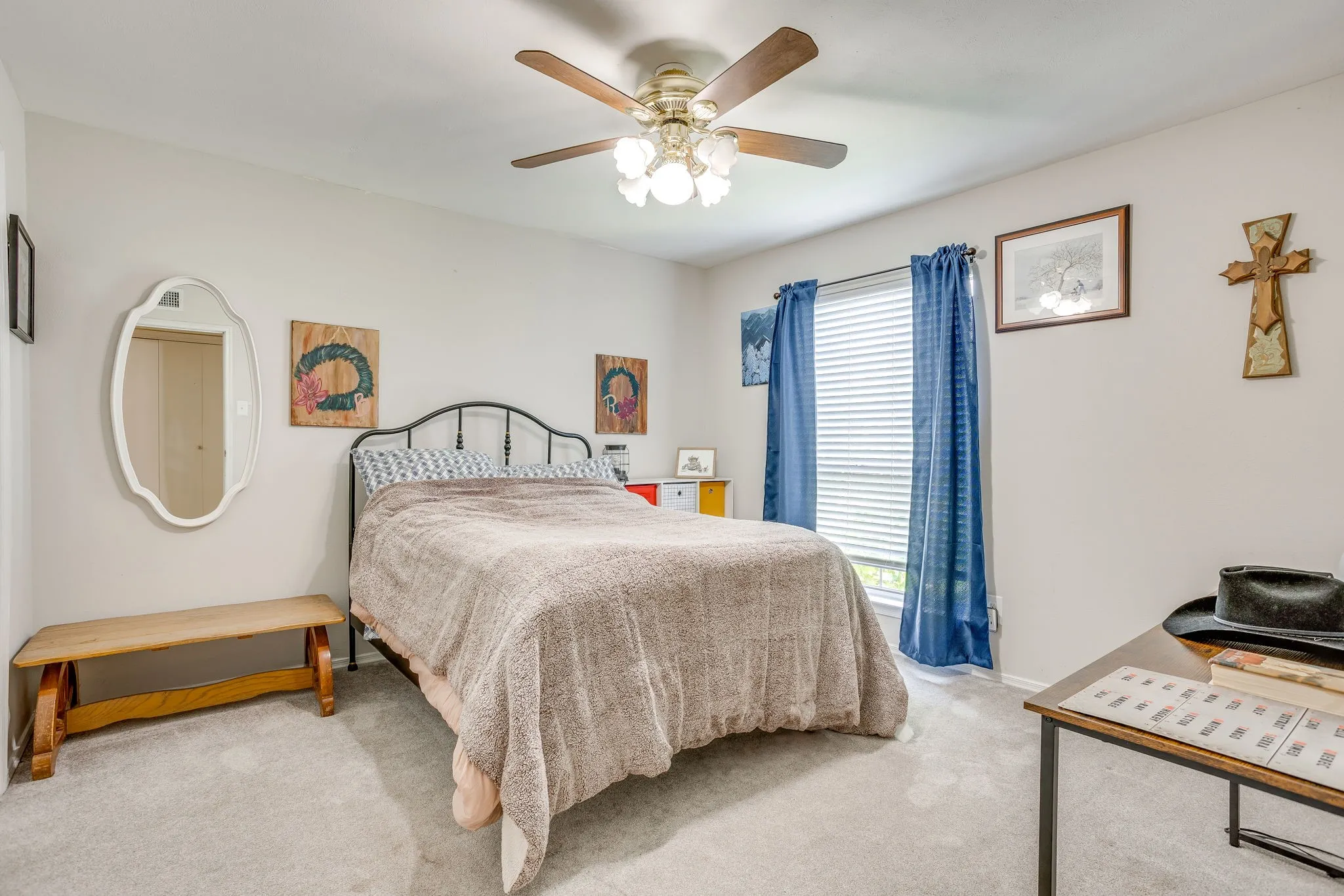Carpeted room featuring a ceiling fan with integrated lighting, a window with blinds, and white walls
