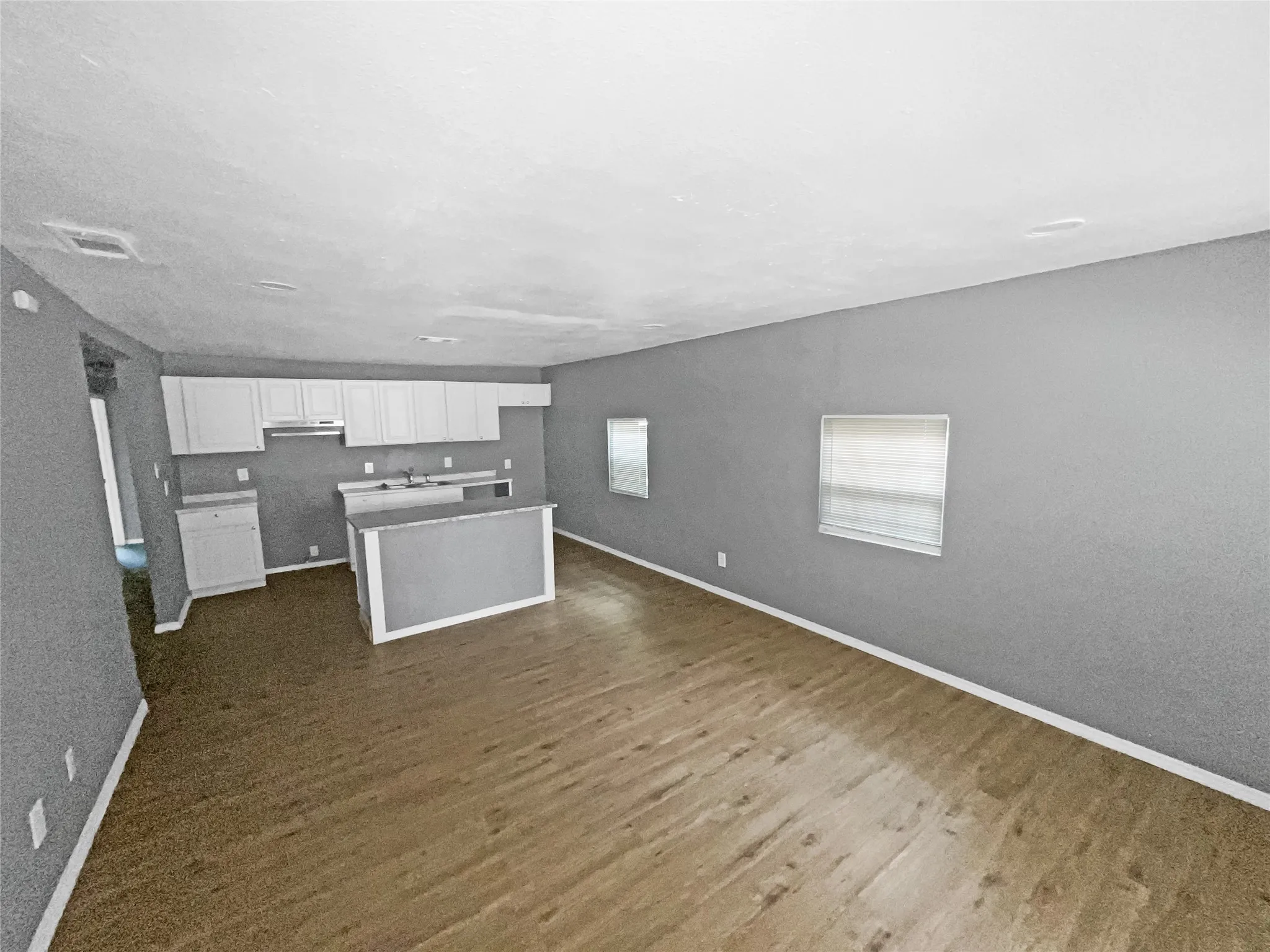 Open concept living space featuring wood-finish flooring