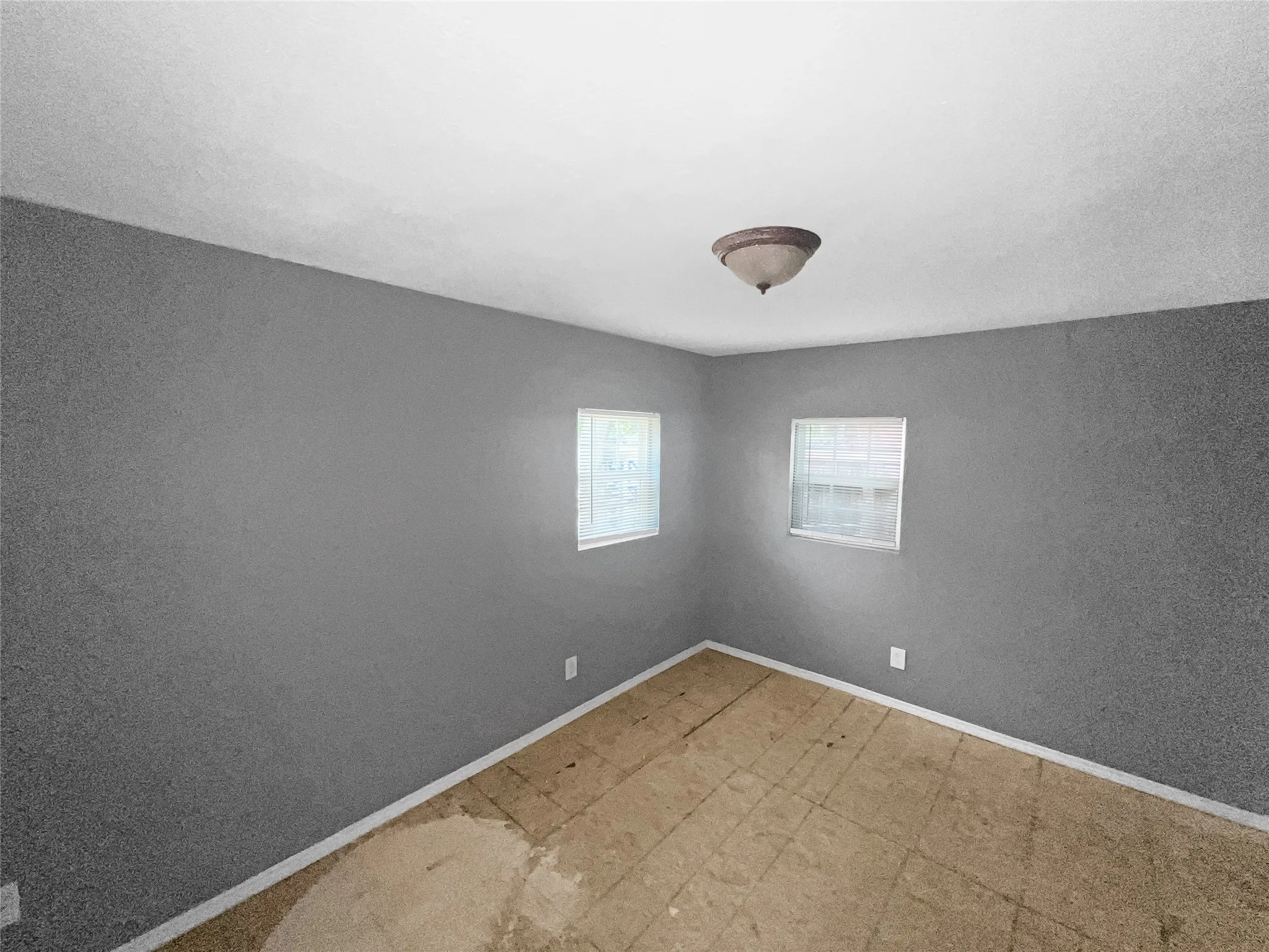 Room with gray walls and a ceiling-mounted light fixture