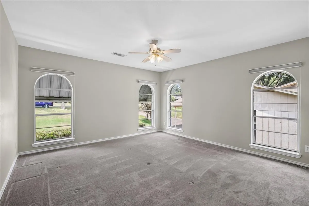 #2 Primary Bedroom on the street side with plenty of natural light through 4 floor to ceiling windows and an ensuite bathroom