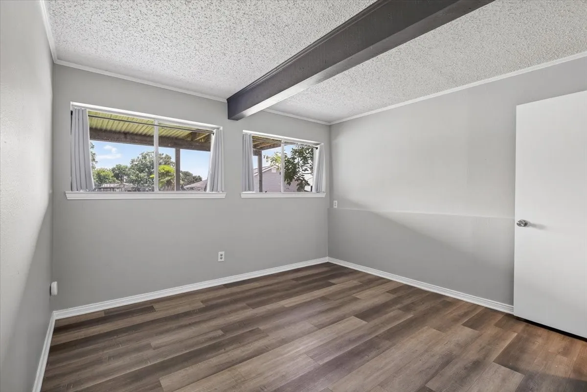 #3 Primary Bedroom with ensuite bathroom, lake view, located on lakeside elevation in downstairs walk-out basement which has a living room or game room with fireplace and access to lakeside yard.