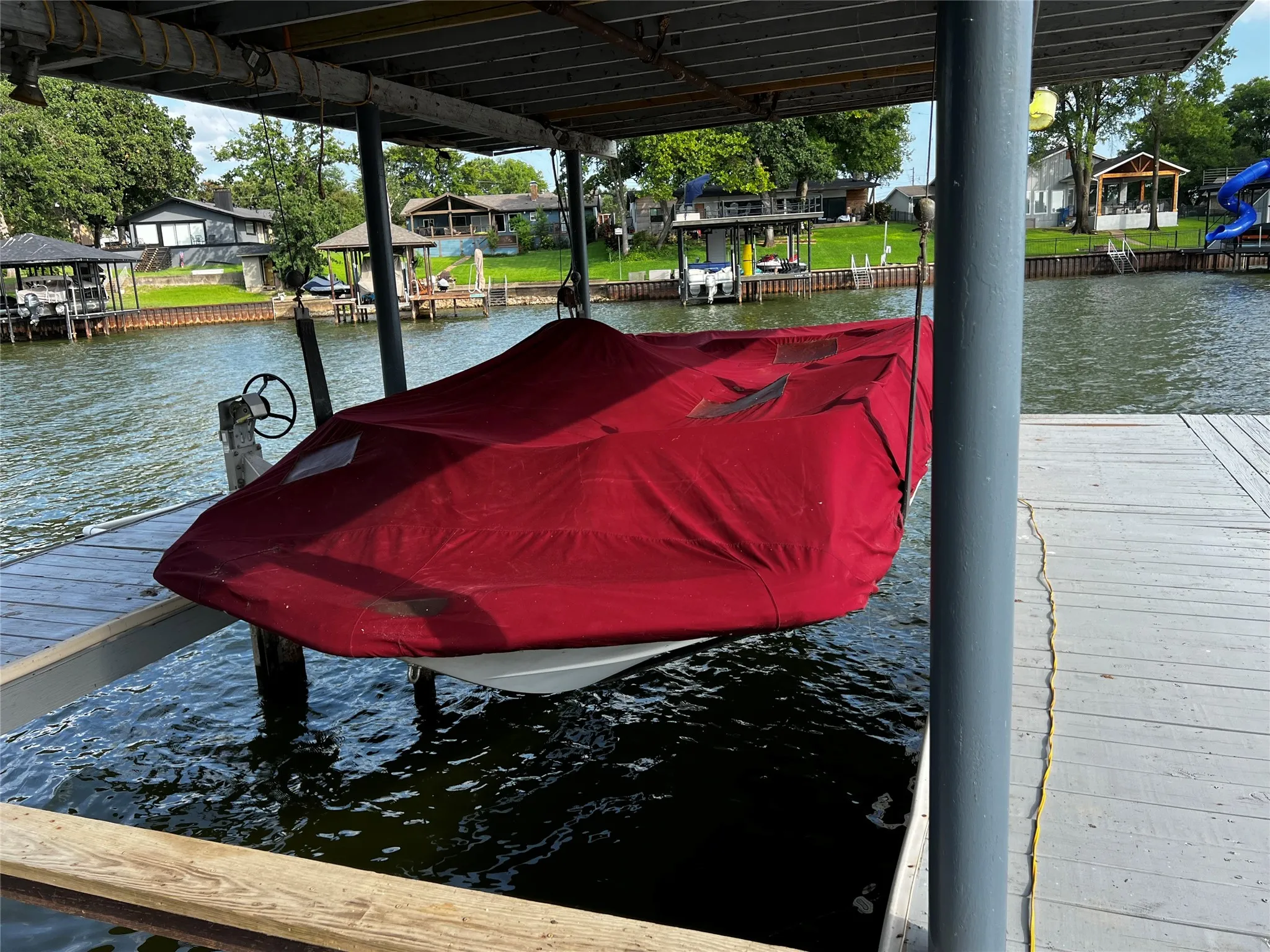 Covered boat lift with direct water access and dock space
