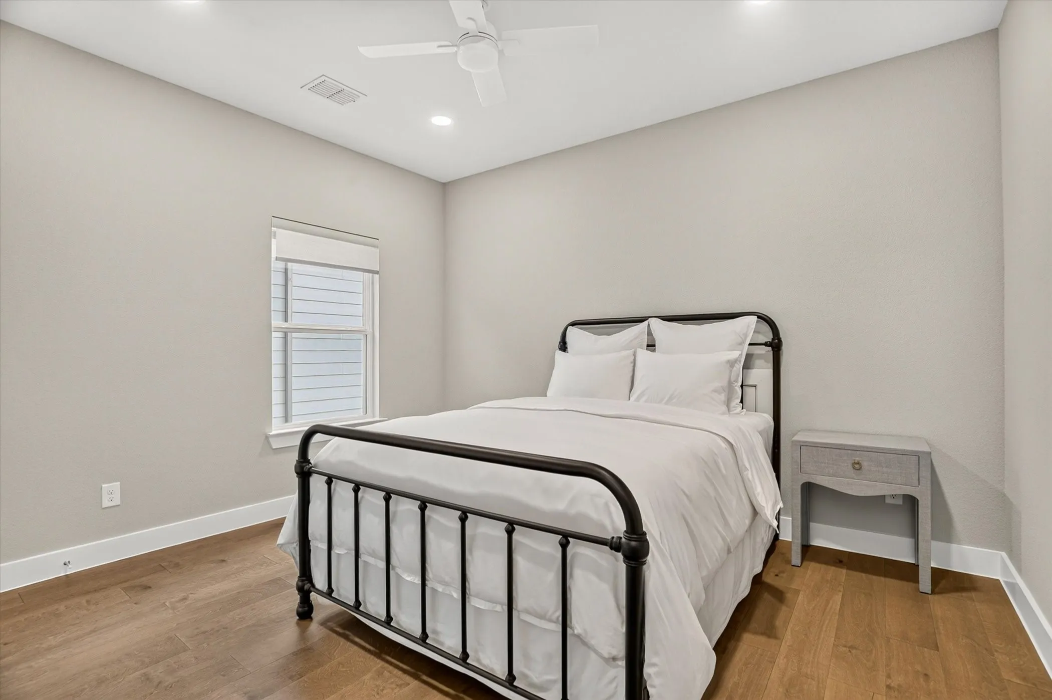 Bedroom featuring wood-finish flooring, recessed lighting, and a ceiling fan