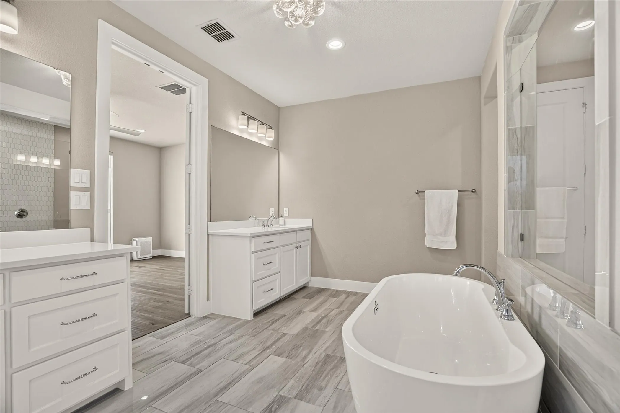 Freestanding soaking tub with floor-mounted faucet