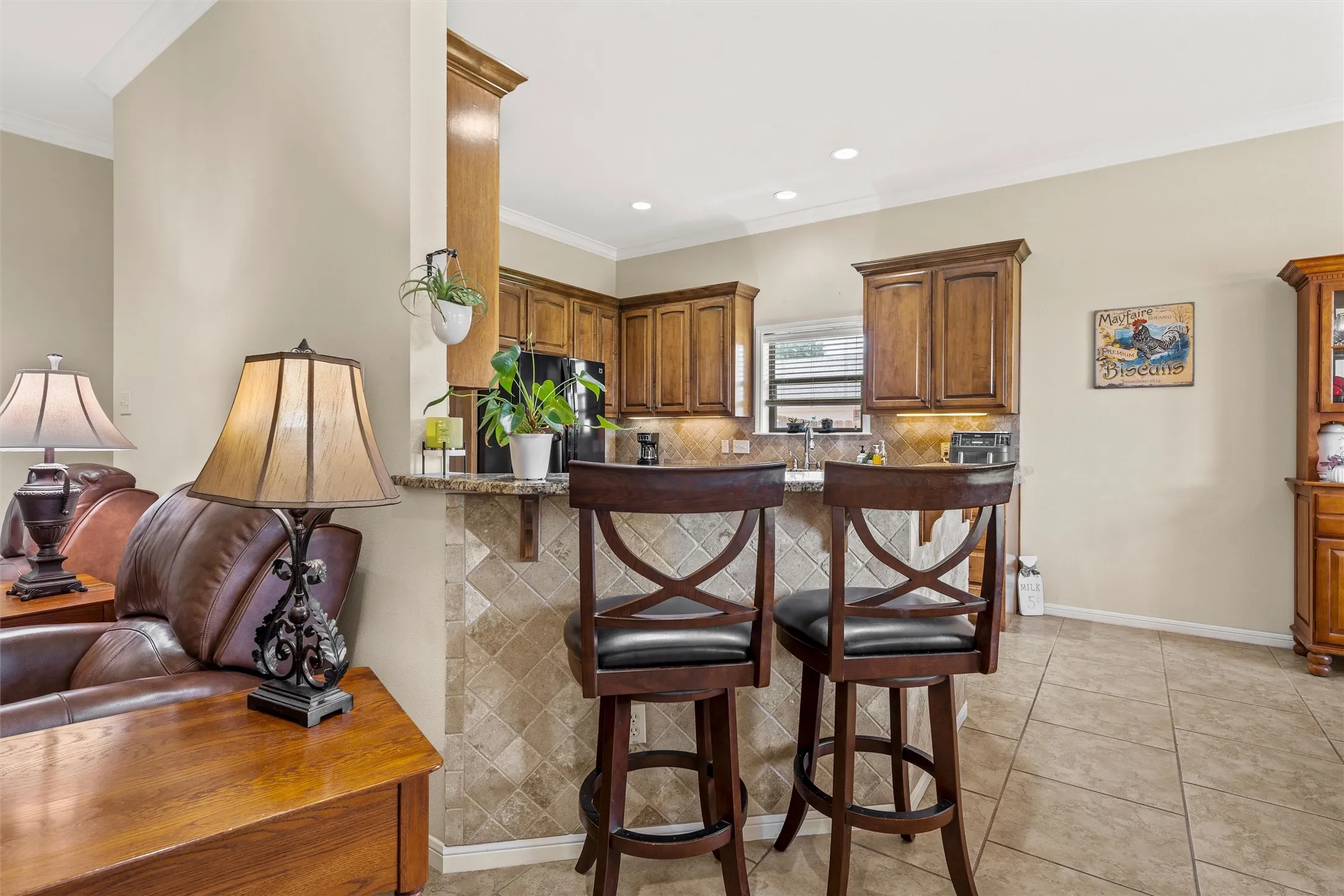Kitchen bar area featuring a granite countertop, tiled backsplash, and recessed lighting